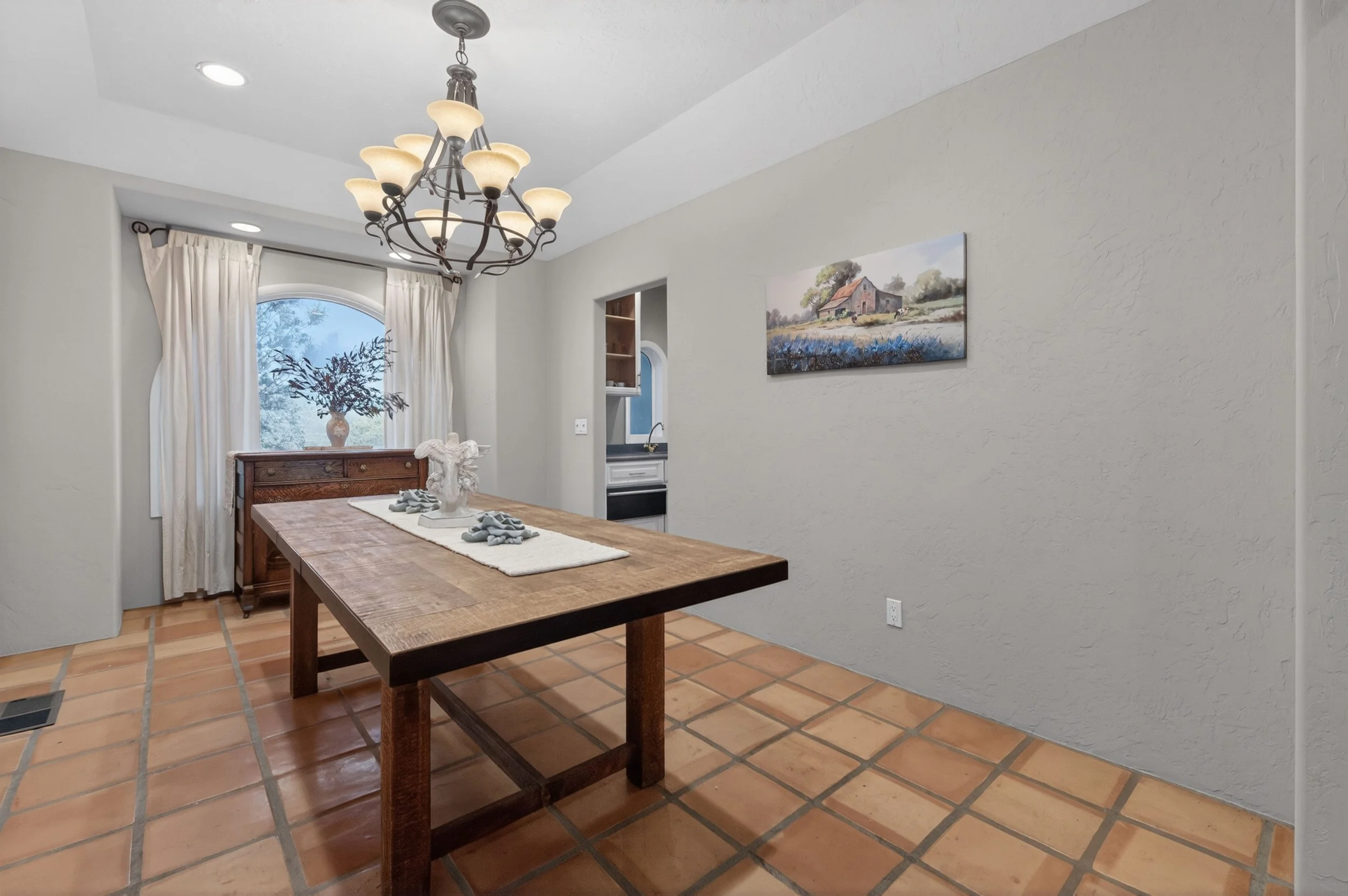 Elegant dining space at Airola Ranch with chandelier lighting, large windows, and refined California foothill estate design