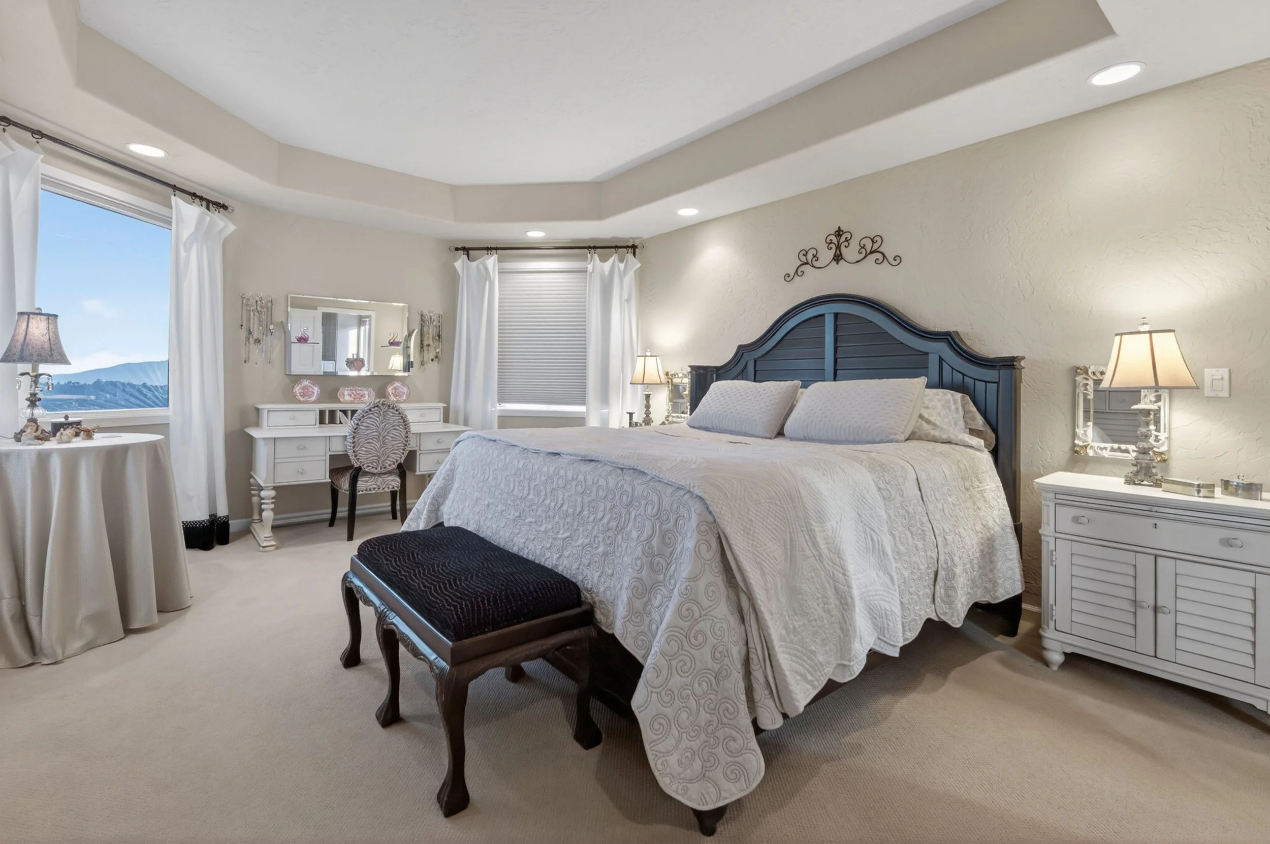 Elegant bedroom retreat at Airola Ranch with expansive windows, mountain and lake views, and upscale California foothill design.