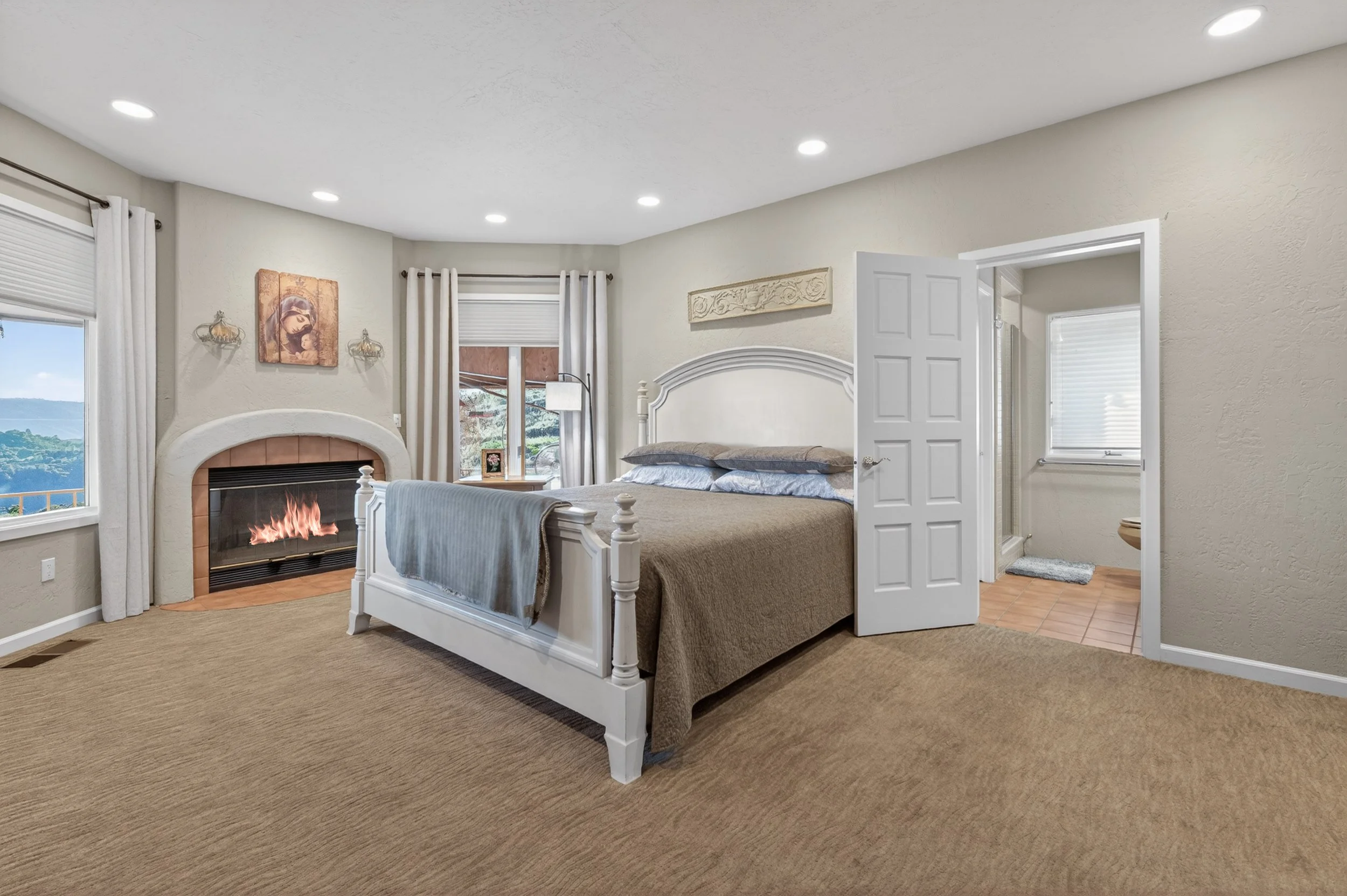 Guest bedroom suite at Airola Ranch in Vallecito California featuring a fireplace, scenic Sierra Foothill views, and elegant luxury estate comfort