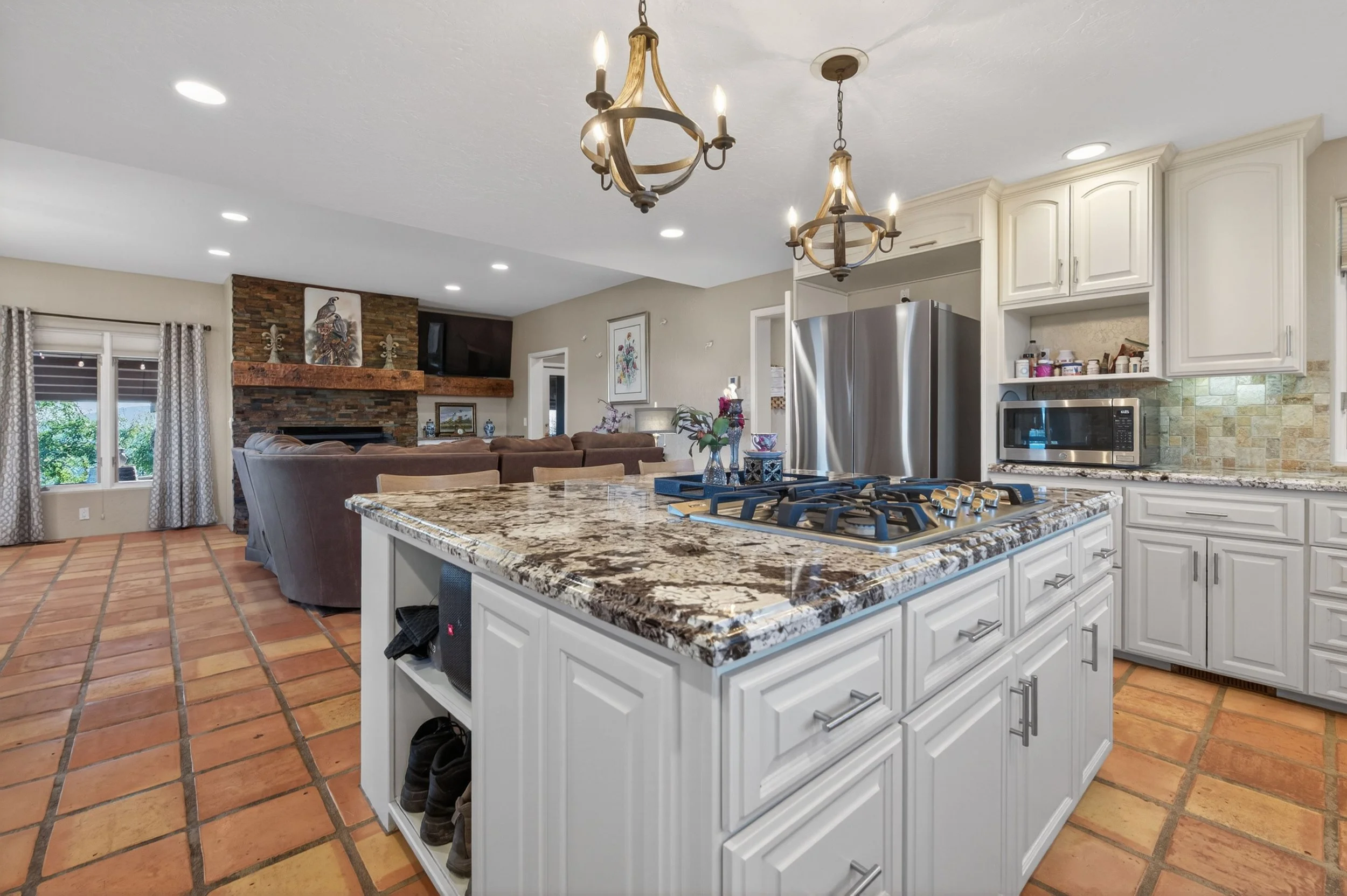 Luxury kitchen at Airola Ranch in Vallecito California featuring granite countertops, custom cabinetry, and indoor-outdoor living with scenic Sierra Foothill views