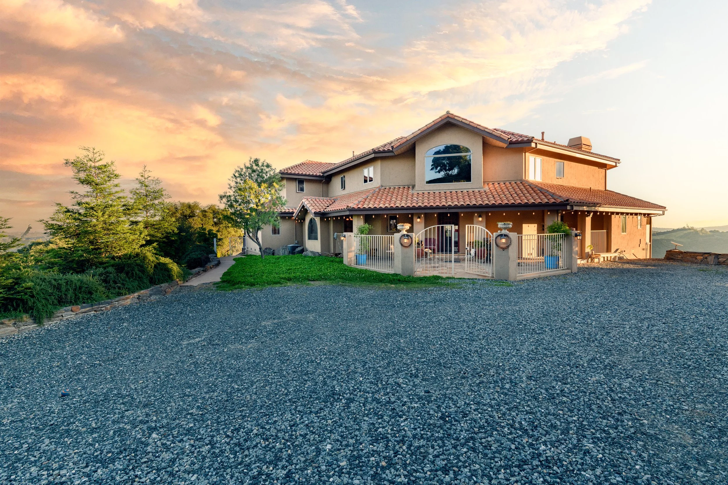 Luxury estate residence at Airola Ranch in Vallecito California featuring Mediterranean-inspired architecture, gated entry, and scenic Sierra Foothill sunset views