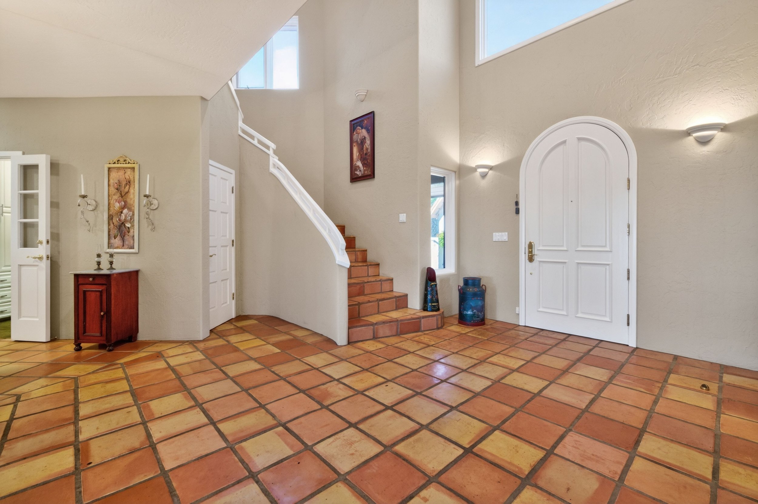 Grand foyer entry at Airola Ranch in Vallecito California featuring terracotta tile flooring, natural light, and elegant Sierra Foothill estate design