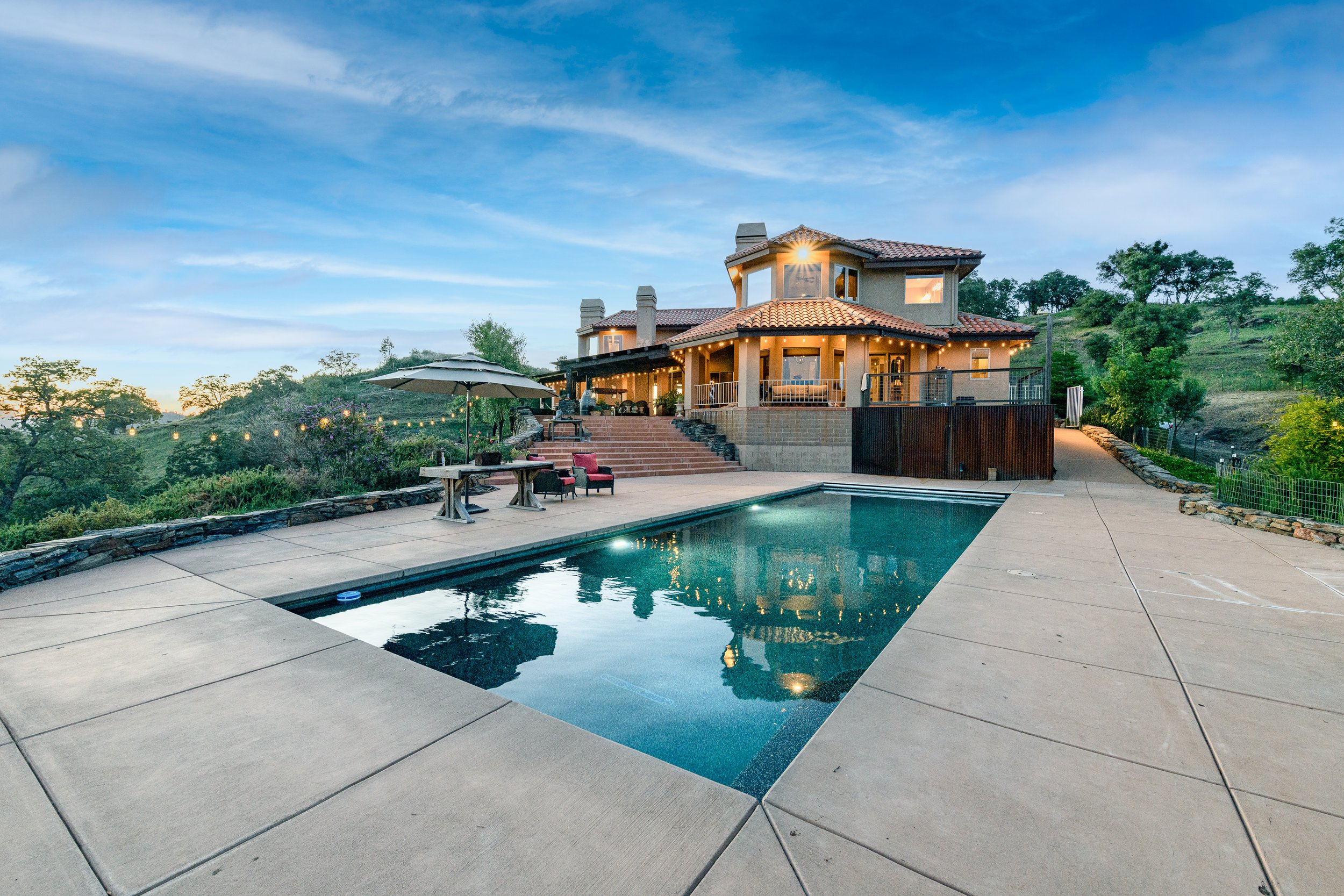 Luxury ranch home on Airola Rd featuring resort style backyard with lake views located in Vallecito, CA.