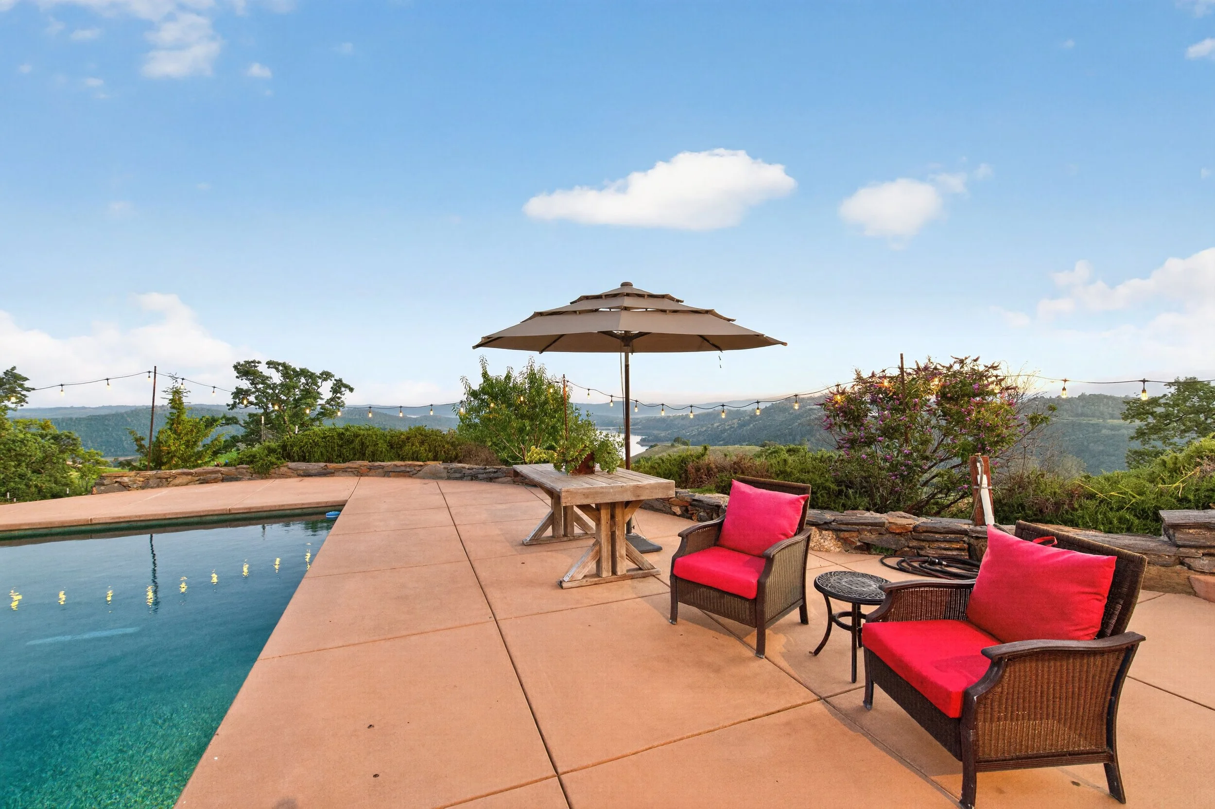 A backyard patio with a swimming pool on Airola Rd overlooking New Melones Lake.