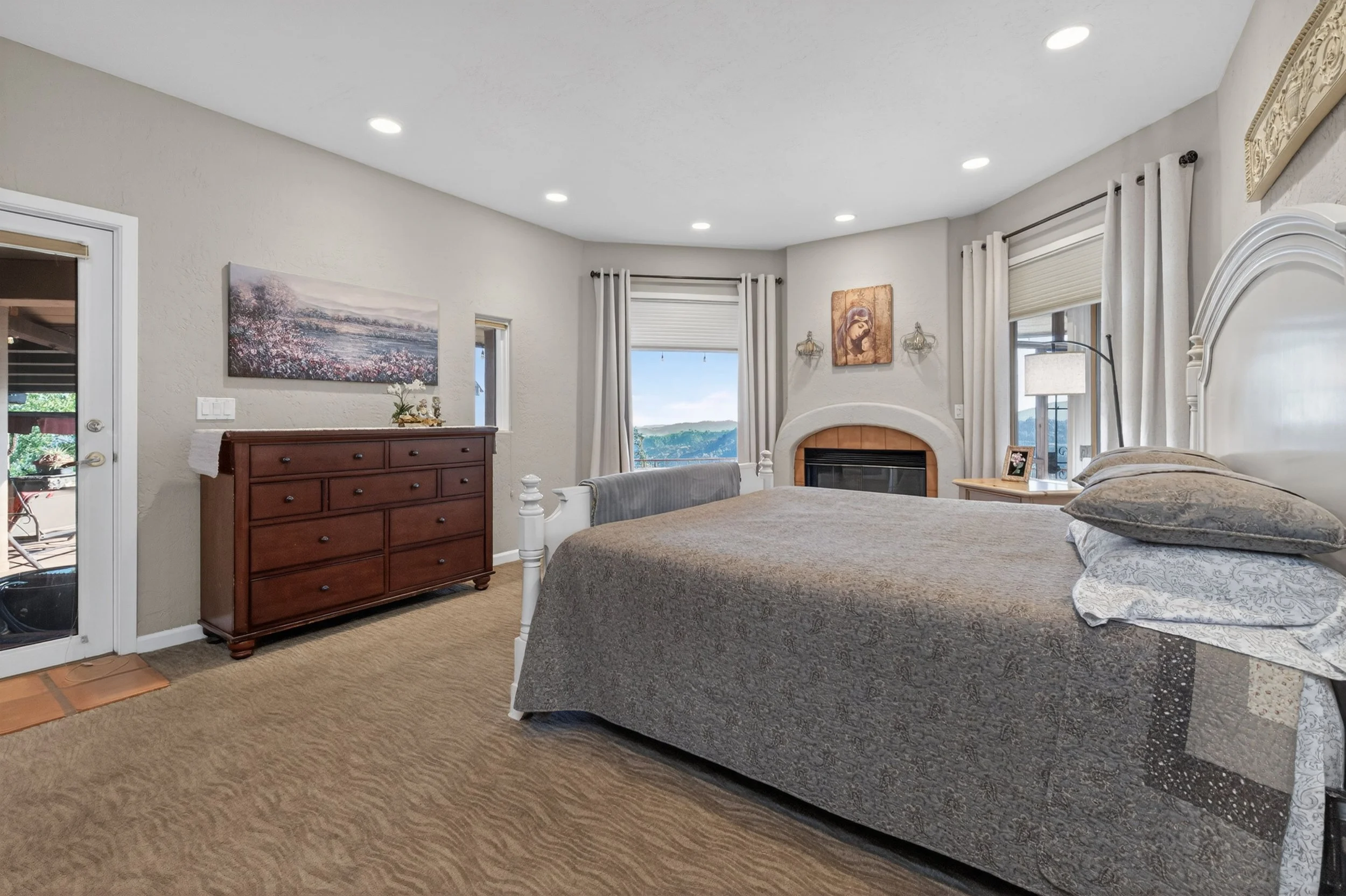 Guest bedroom at Airola Ranch in Vallecito California featuring scenic mountain and lake views, private balcony access, and comfortable luxury estate living