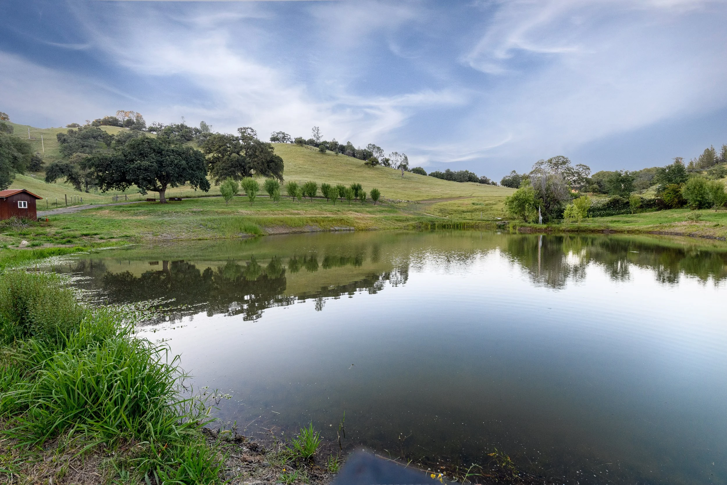 Private ranch pond surrounded by Sierra Foothills landscape in Calaveras County California