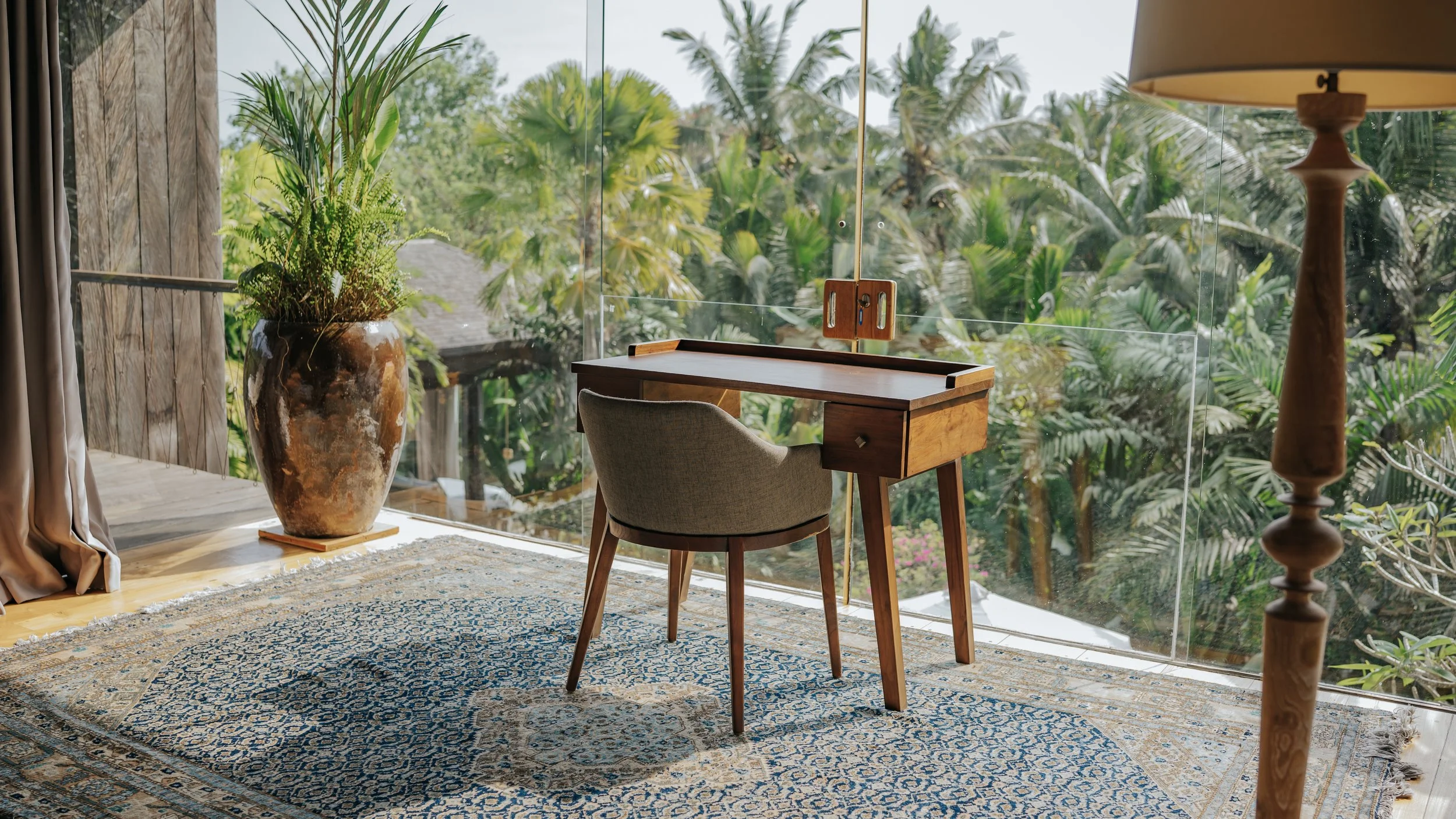 Office chair with desk overlooking the pool and jungle