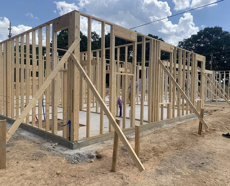 Wood framing construction for a new residential home in Lancaster, SC, showing exterior and interior walls being framed.