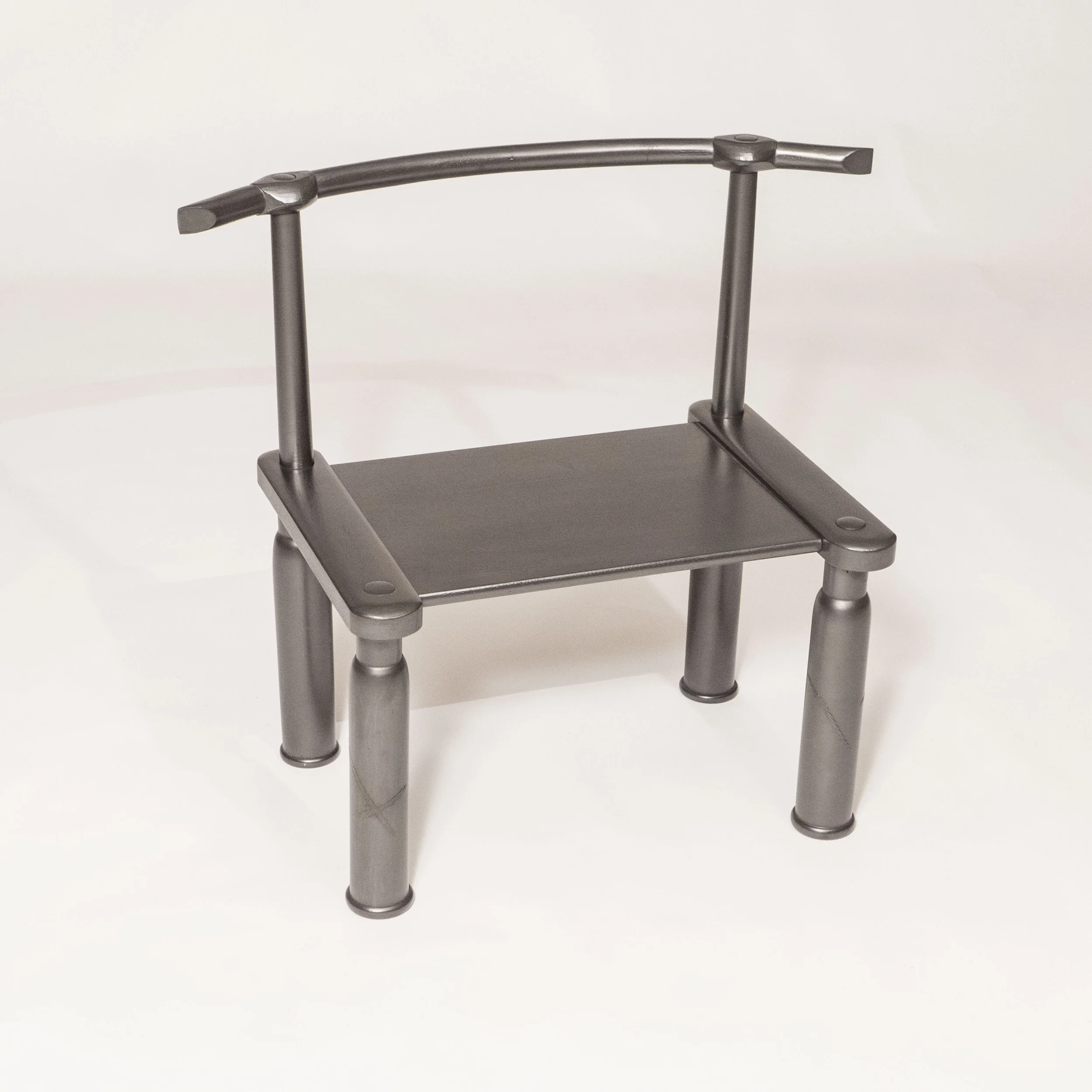 A small metal rolling cart with four legs and a flat black surface, set against a plain white background.