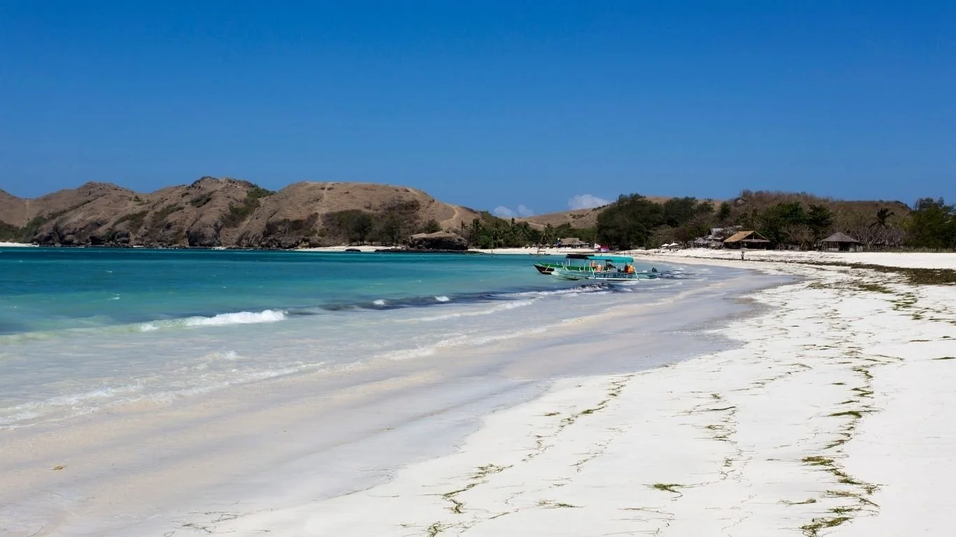 Tanjung Aan Beach with soft white sand, crystal-clear water and coastal scenery near Kuta Lombok.