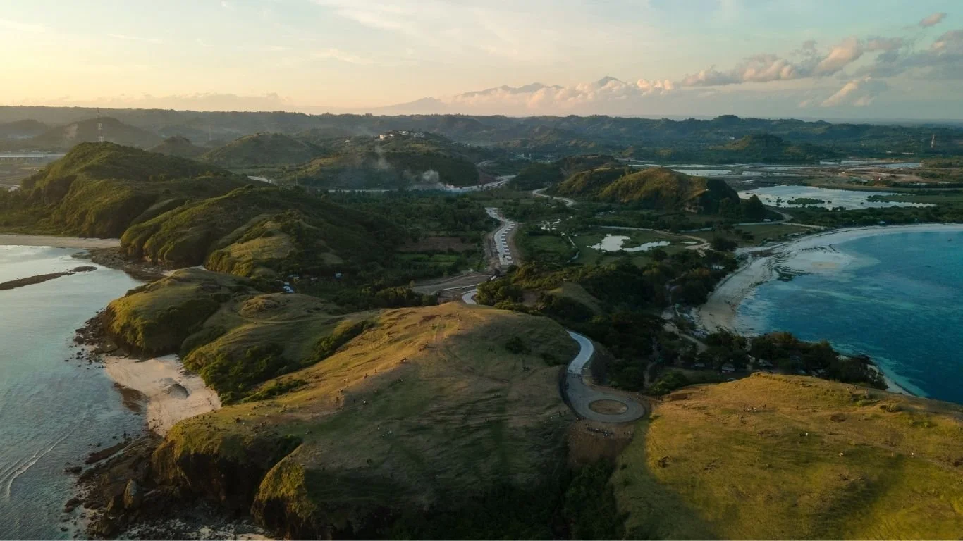 Aerial view from Bukit Merese overlooking the coastline and beaches near Kuta Lombok at sunset.
