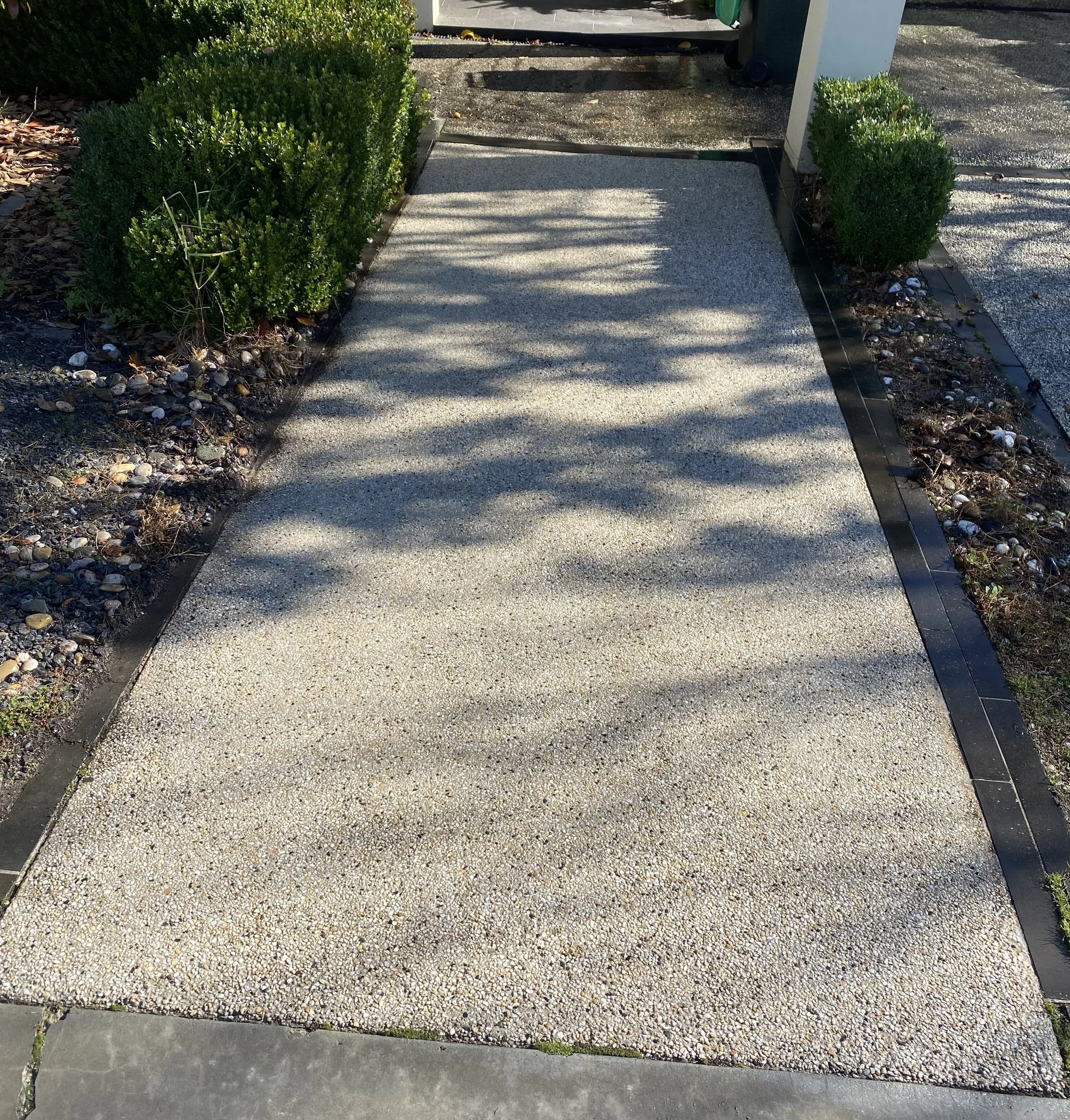 Professional pressure washing of a residential pathway restored to a clean finish.