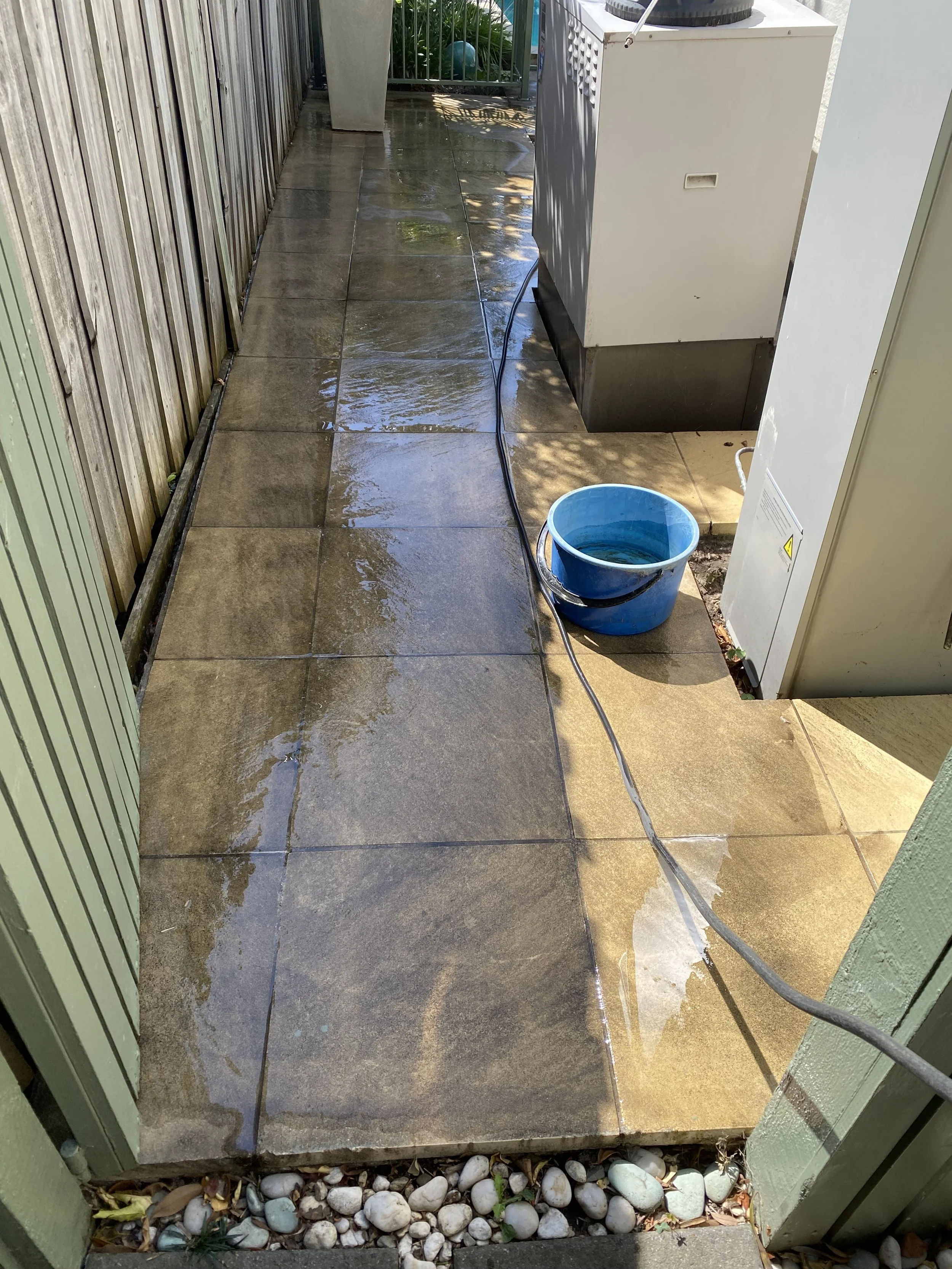 Outdoor tiled pathway in Templestowe before professional pressure cleaning, showing dirt, algae and surface staining.