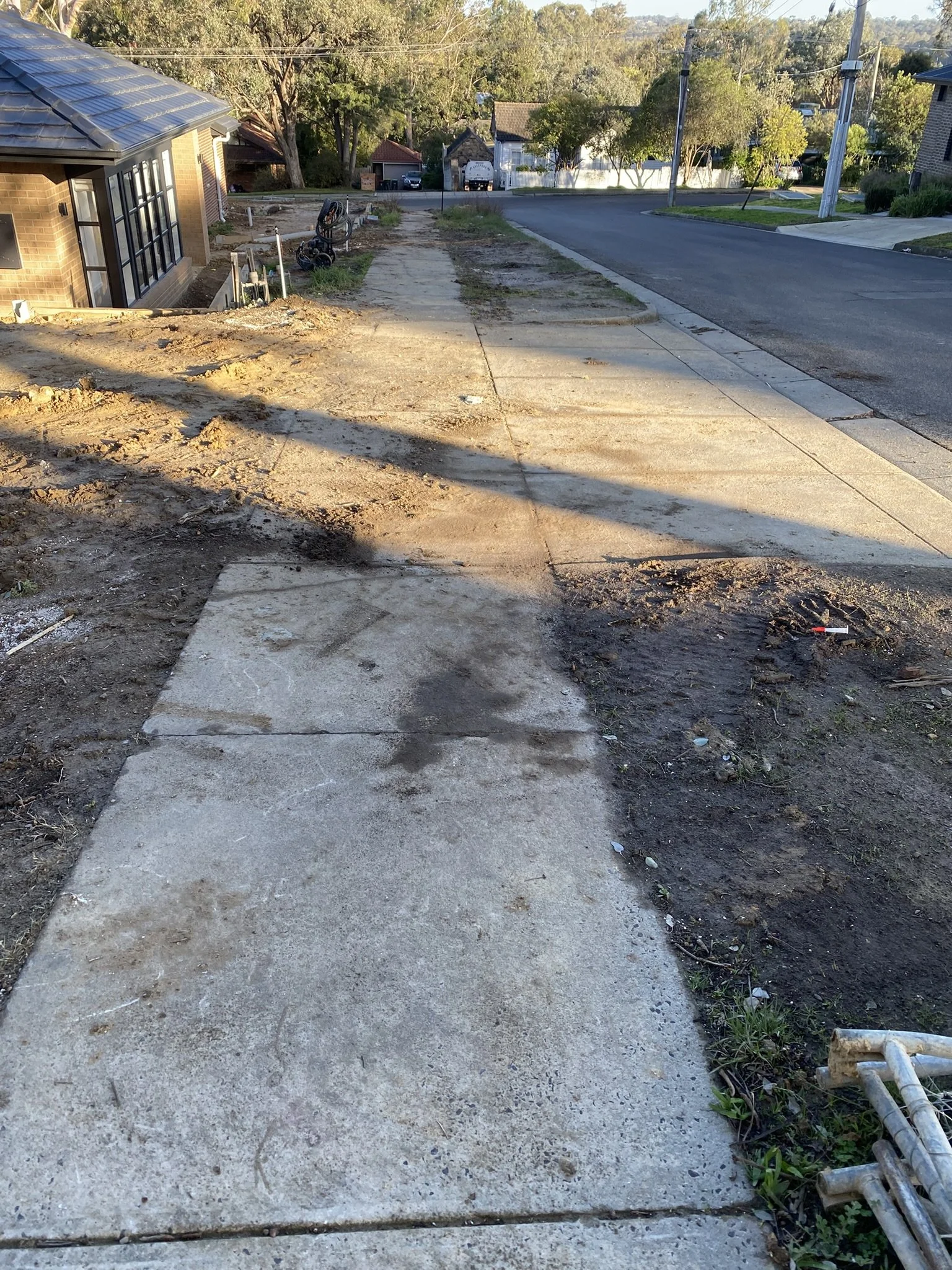 Professional pressure washing restoring a residential footpath before a clean finish.