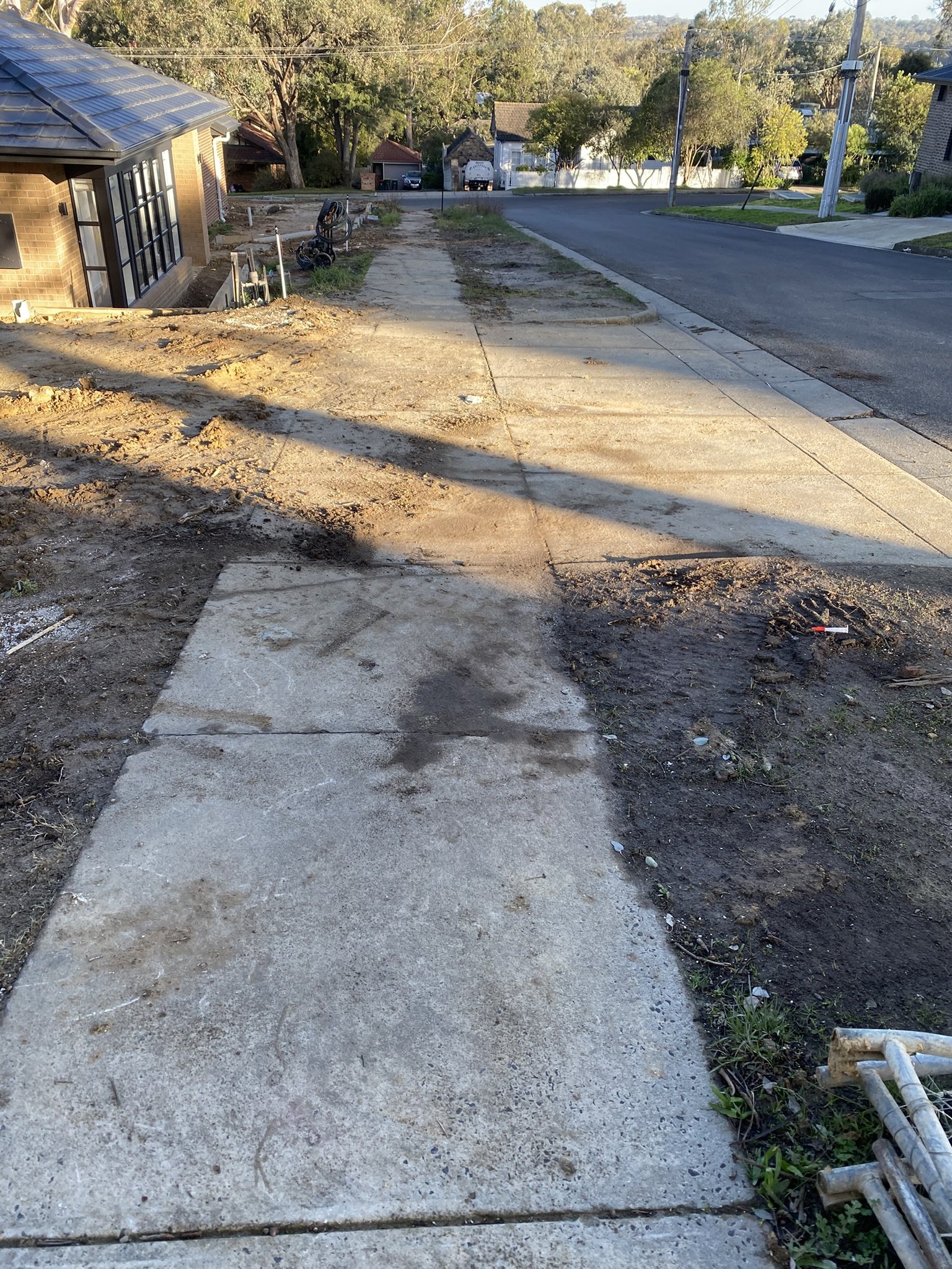 Concrete footpath in Templestowe before professional pressure cleaning, showing built-up dirt, mud and surface staining.