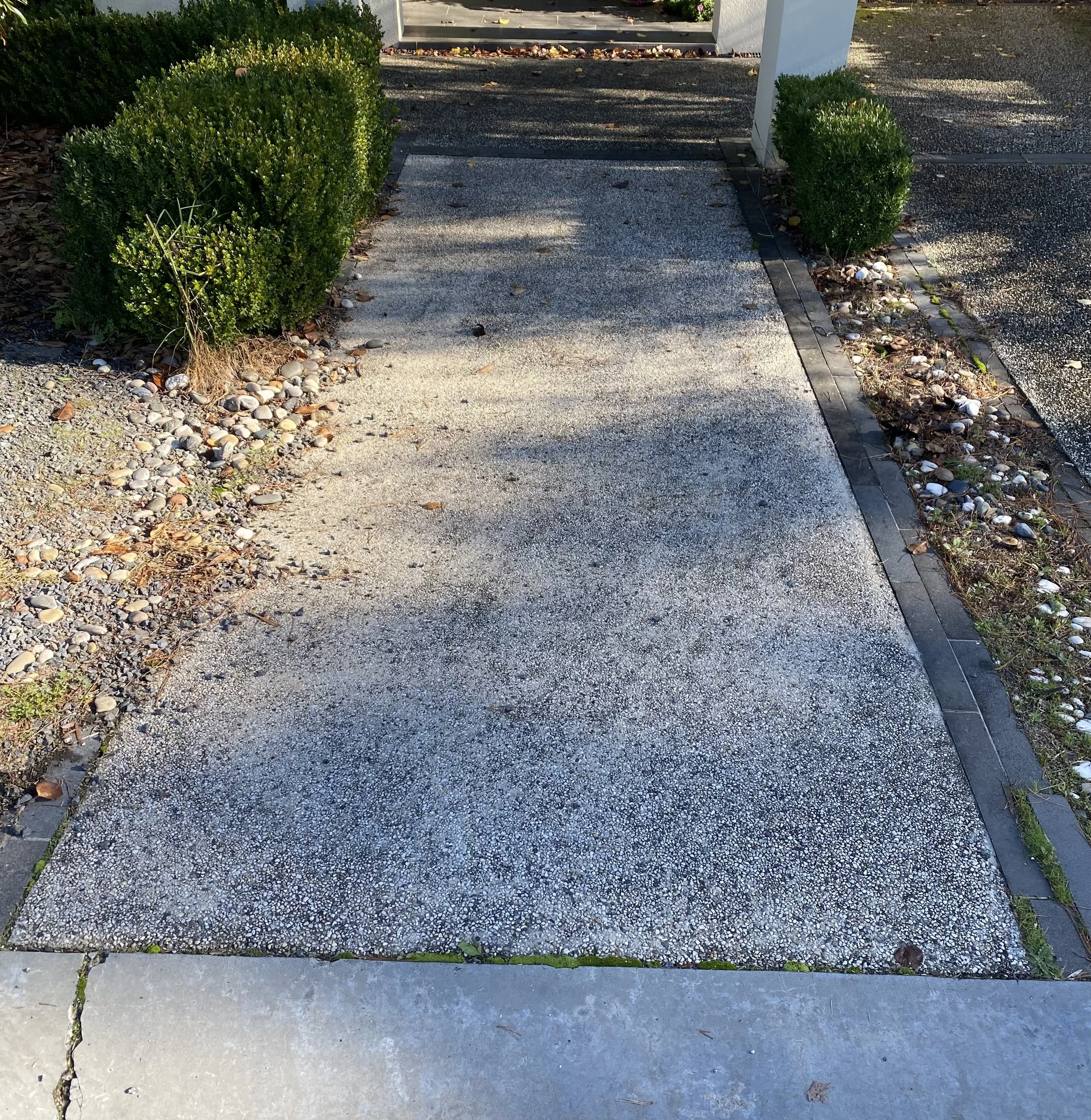 Exposed aggregate pathway in Templestowe before professional pressure cleaning, showing dirt, organic growth and surface discolouration.