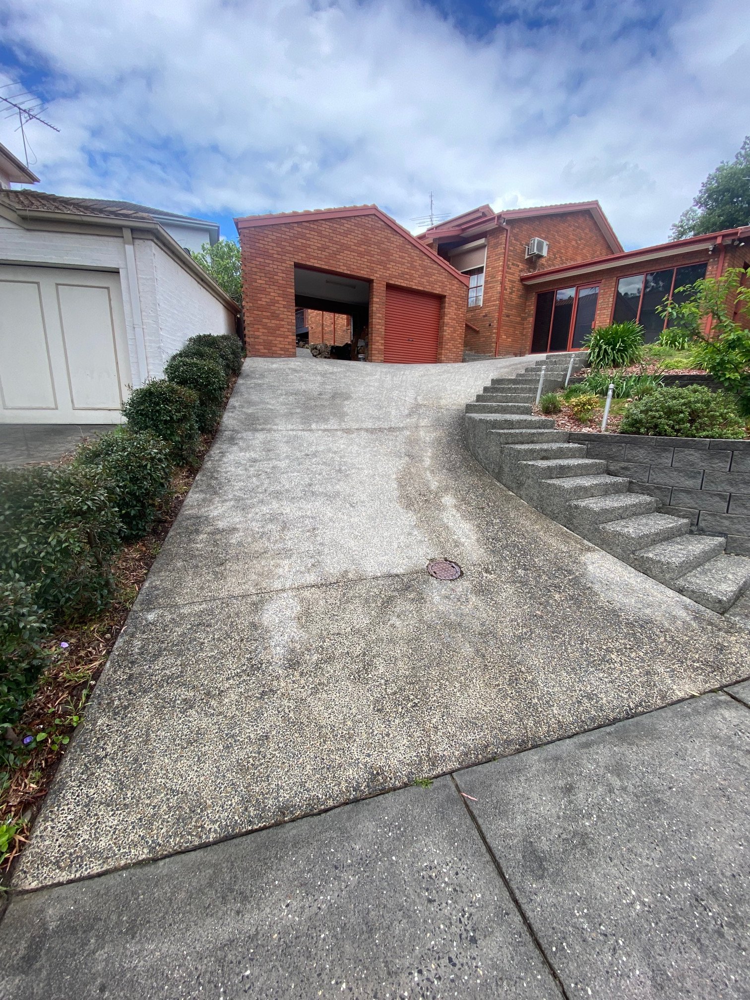 Concrete driveway restored after professional pressure cleaning by Jet Power Pressure Washing.