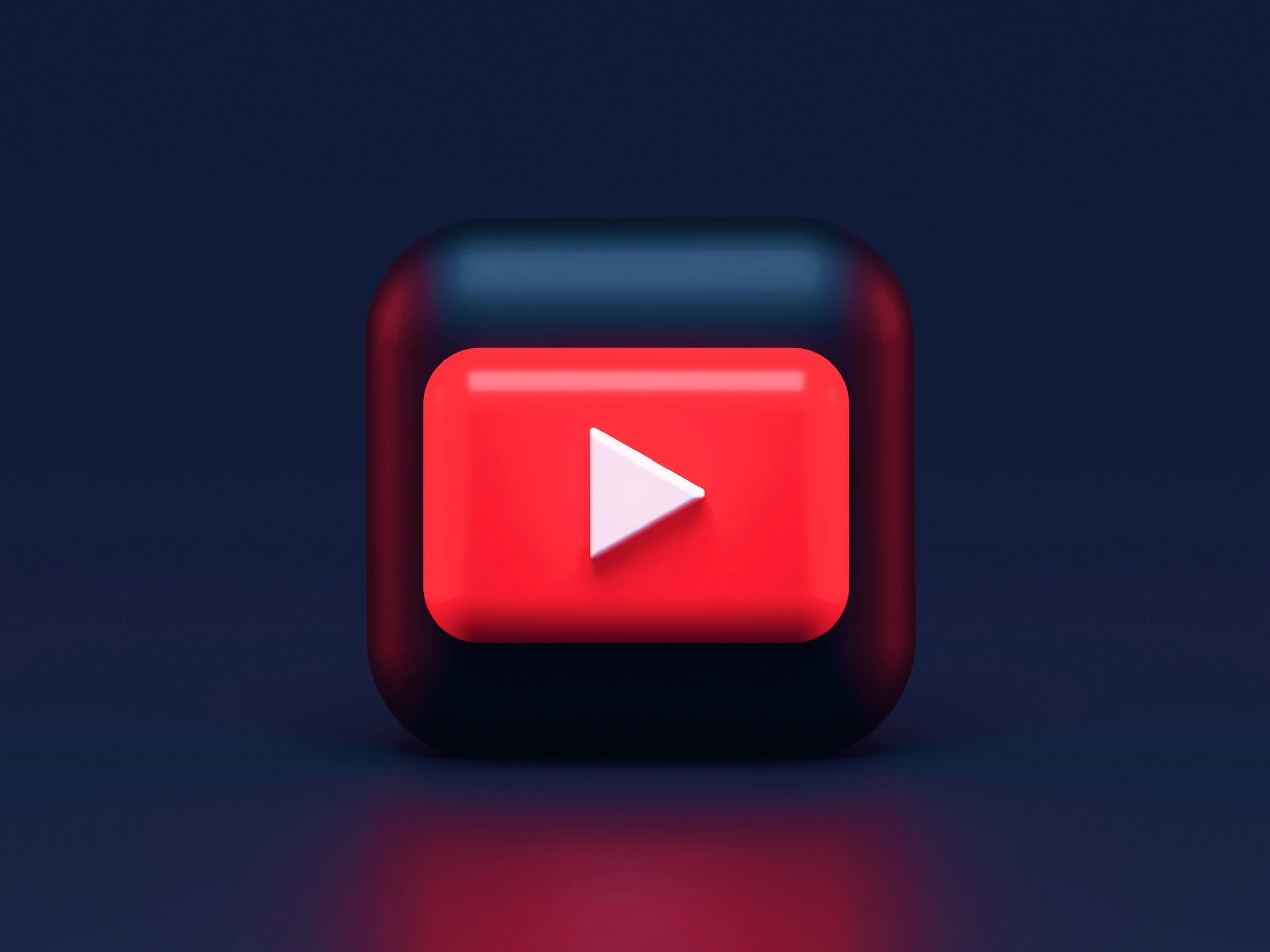 Close-up of a red play button icon on a black background.