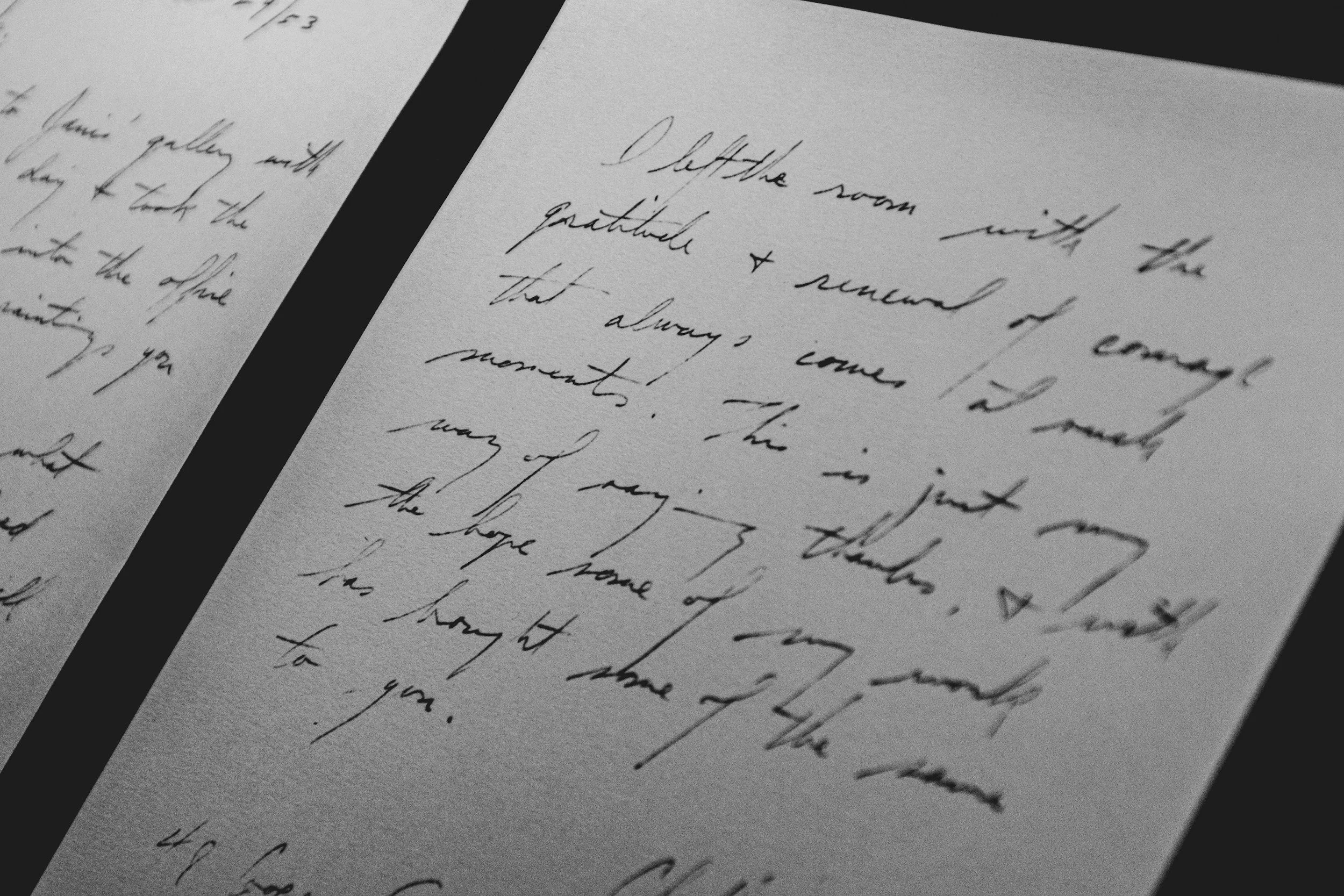 Close-up of handwritten letter on white paper with black border.