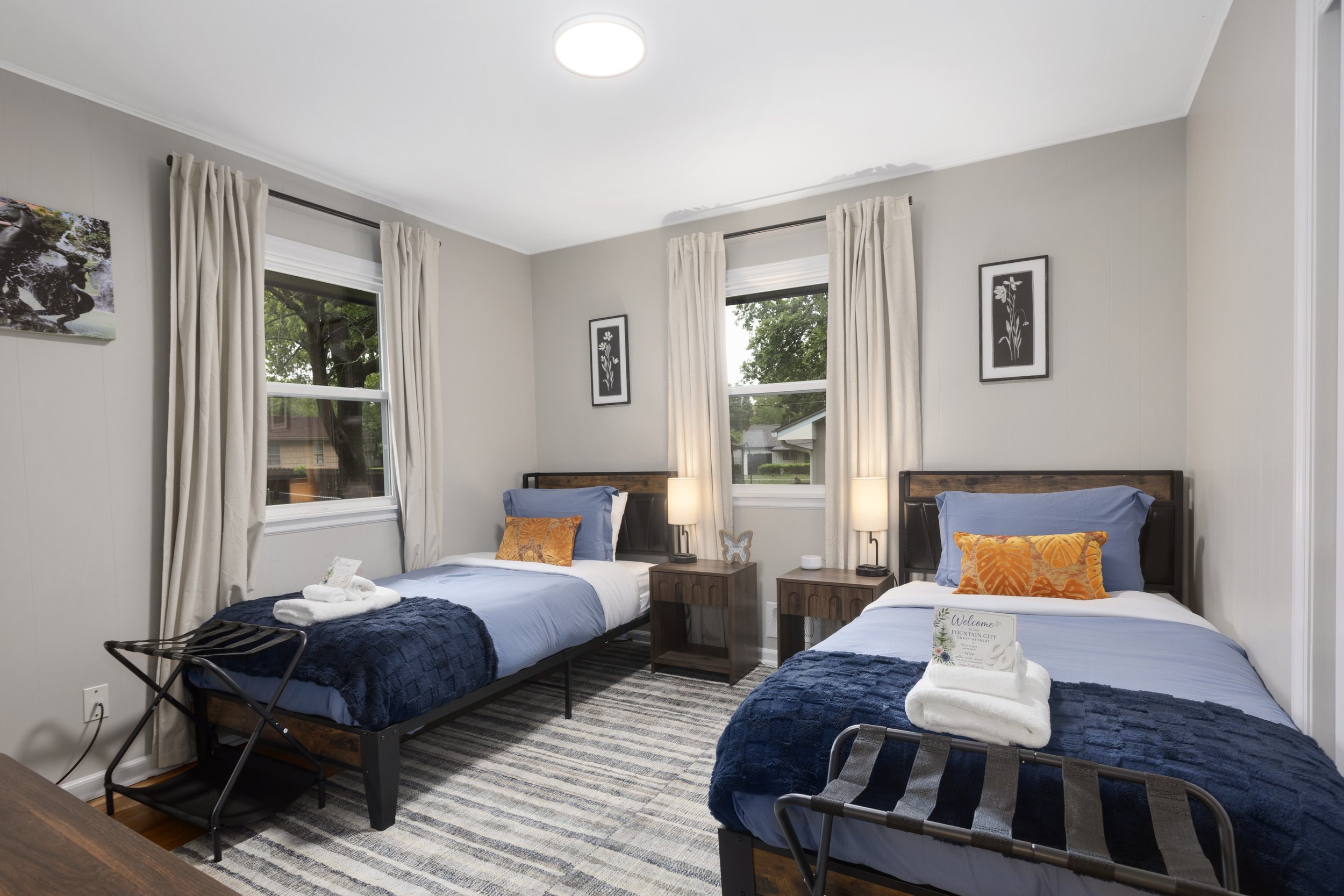 Comfortable guest bedroom at Fountain City Creative Retreat near Kansas City featuring boutique accommodations, twin beds, cozy décor, and welcoming lodging designed for scrapbook retreats, quilting weekends, and creative group stays.