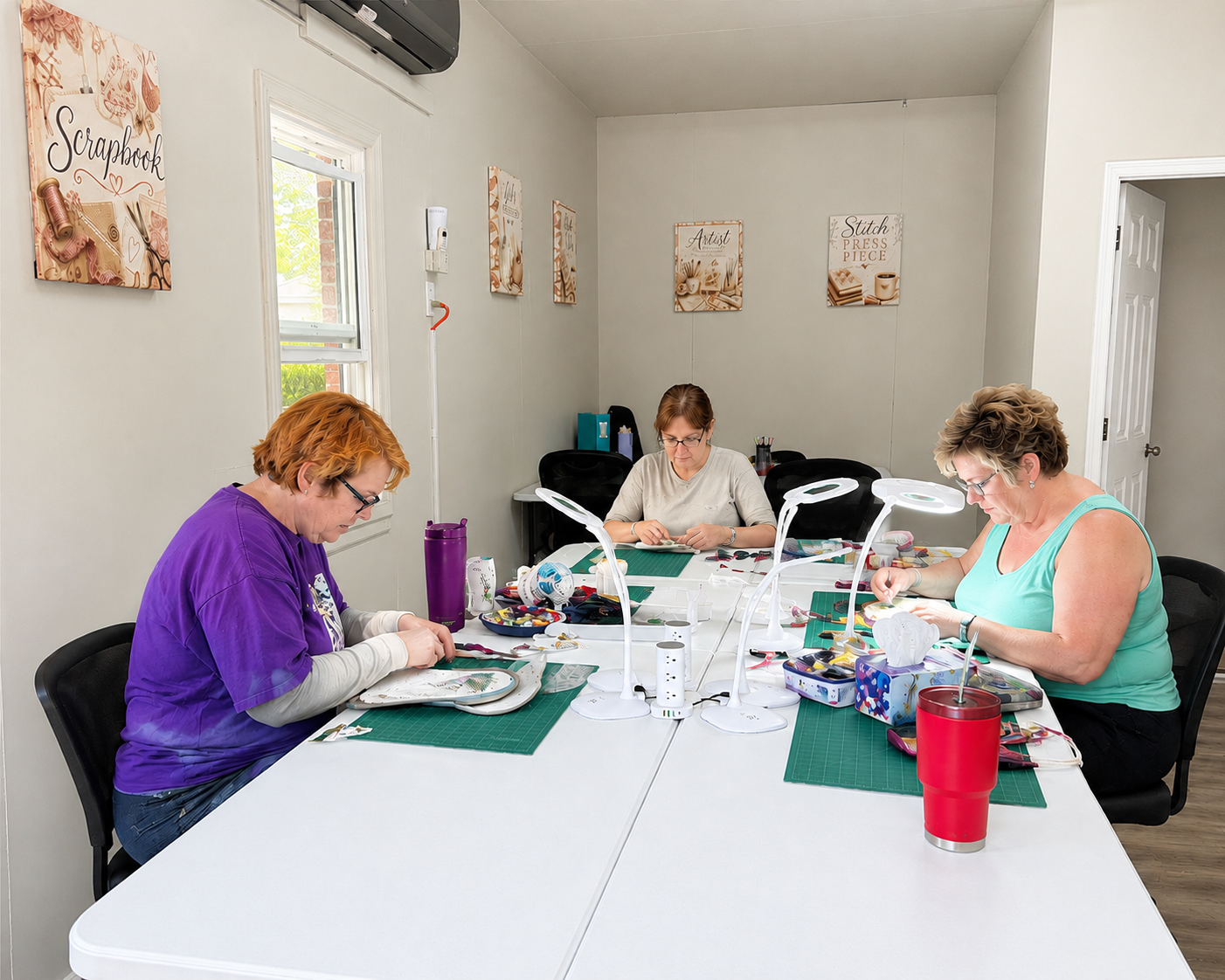 Creative guests working on projects together at Fountain City Creative Retreat featuring spacious crafting tables, comfortable workstations, and an inspiring creative environment designed for scrapbook, quilting, and maker retreats near Kansas City.