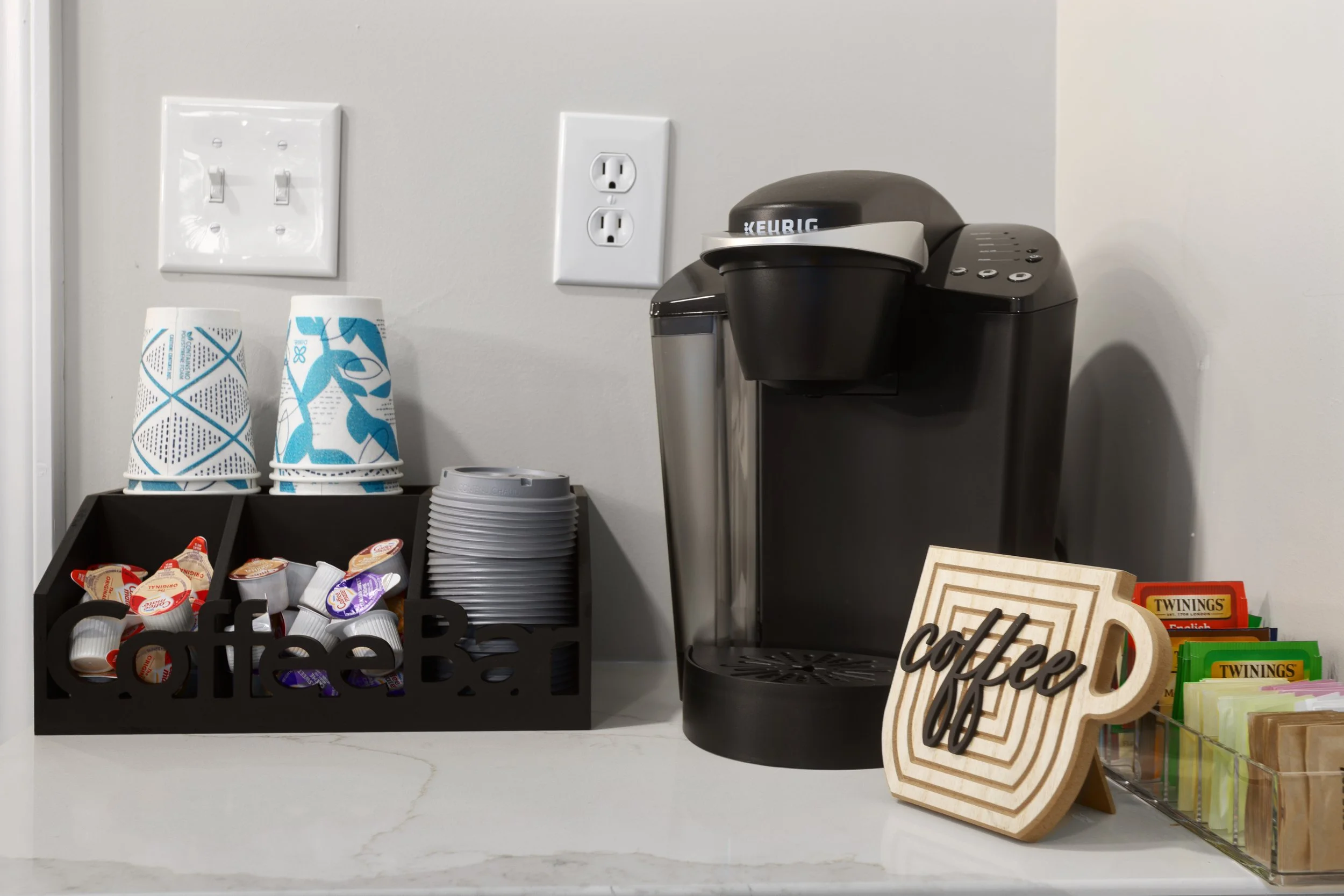 Welcoming coffee station and guest refreshment area at Fountain City Creative Retreat featuring complimentary coffee, snacks, and thoughtful hospitality touches for scrapbook, quilting, and creative retreat weekends near Kansas City.