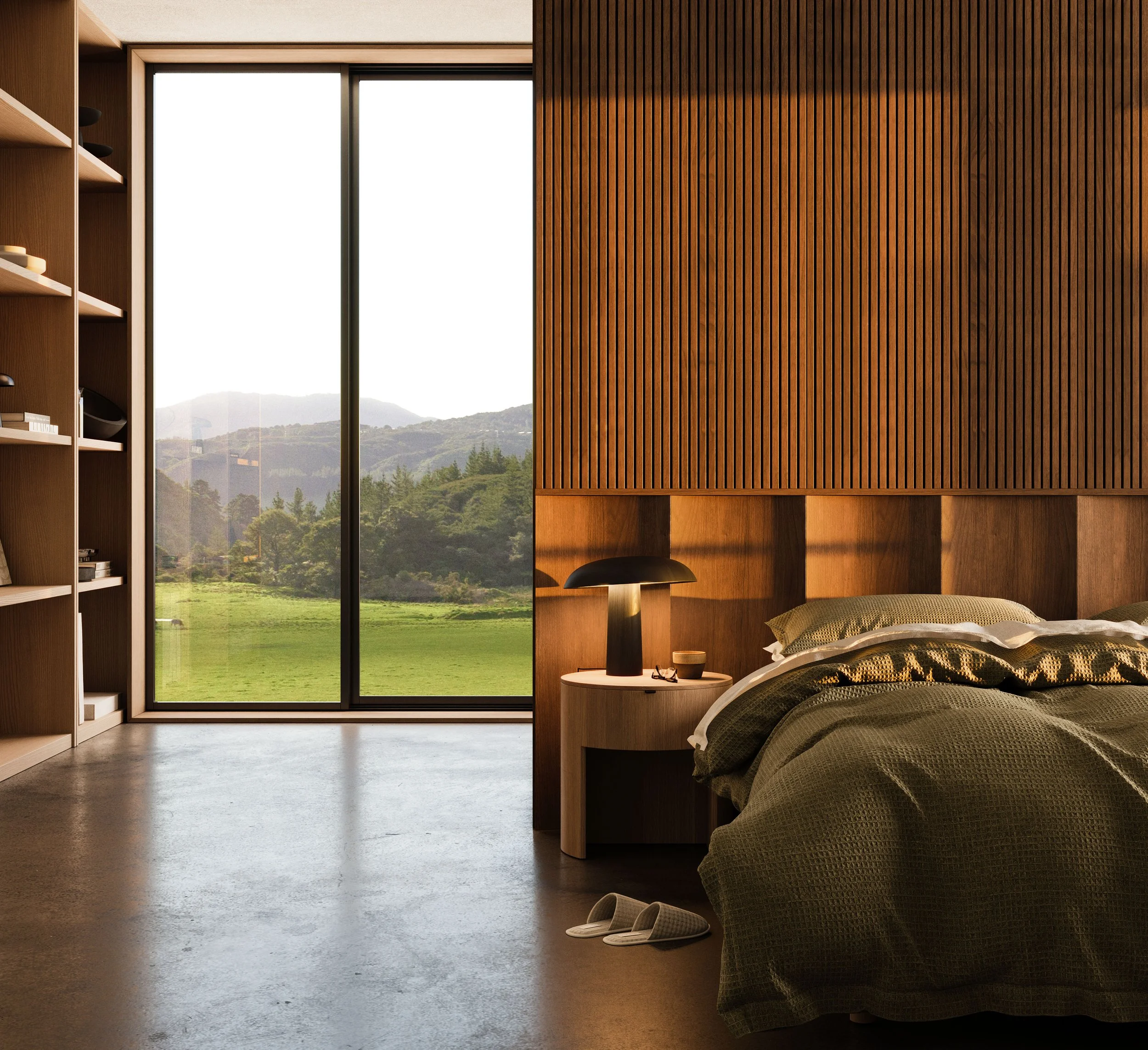 A bedroom with a large window showing a green landscape and mountains outside, a wooden headboard, a bedside table with a black lamp and small objects, a bed with green and patterned bedding, a pair of slippers on the floor, and a wooden bookshelf on