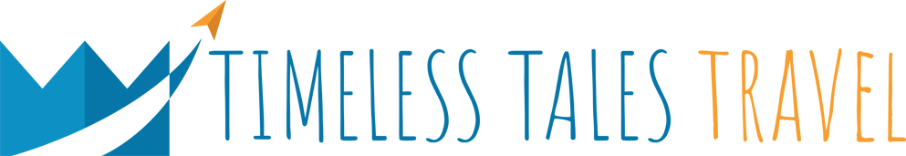 Logo for Timeless Tales Travel featuring stylized mountain, arrow, and text