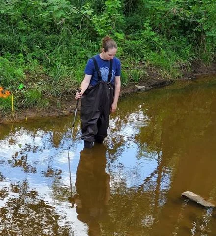 Tiffany Brault doing volunteer water monitor work in a Fond du Lac County creek