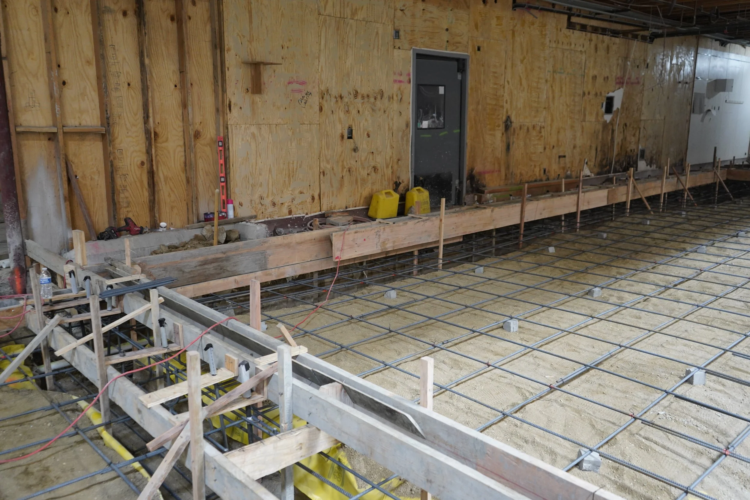 Concrete forming for a new steel stud wall