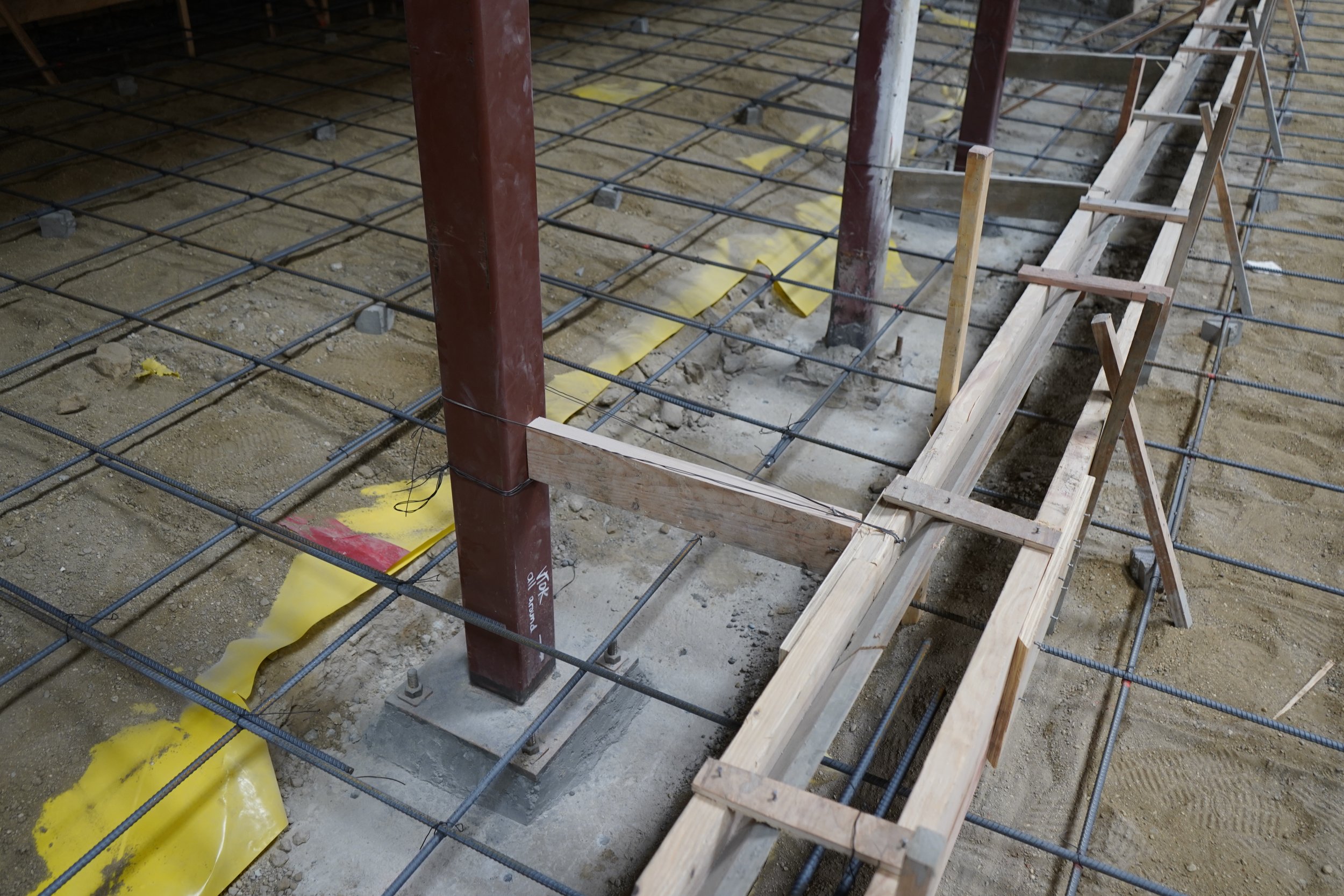 Encasing the existing steel base plate in concrete