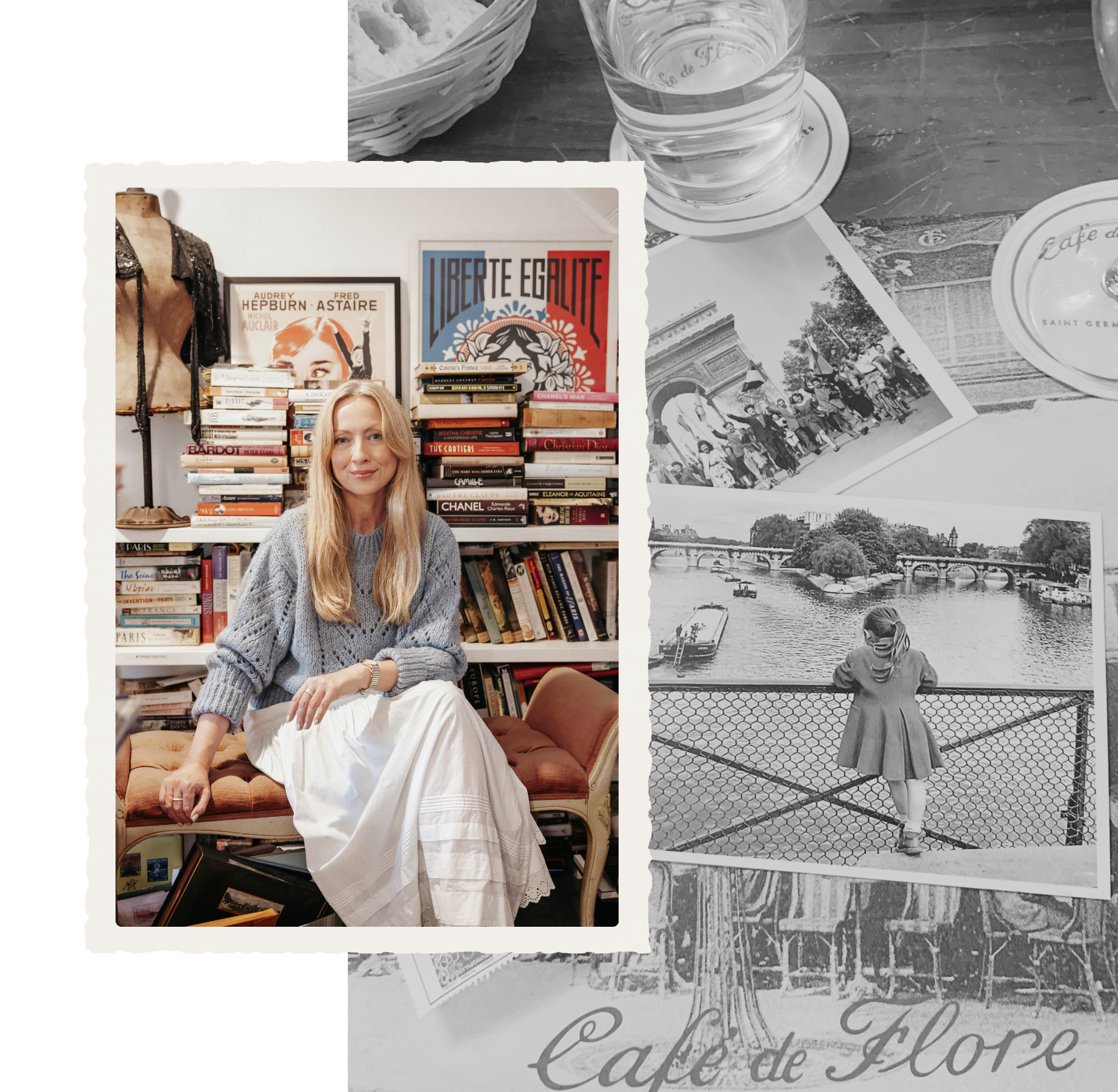 A woman with long blonde hair sitting on a vintage sofa indoors, in front of a shelf stacked with books and art, with posters on the wall behind her. In the background, a photograph of a cityscape with a bridge over a river, and a black-and-white photo of children and a woman by the water, are visible.