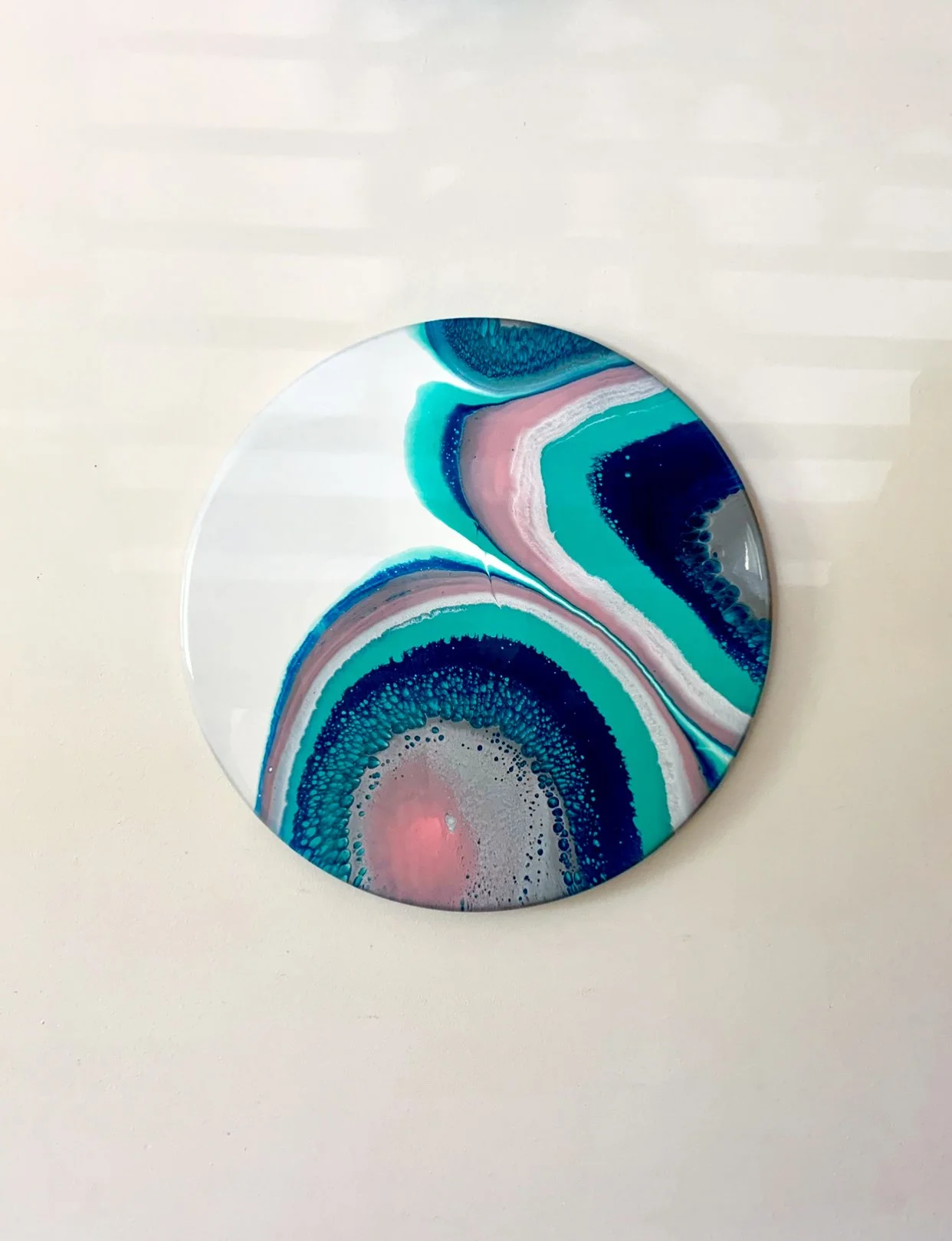 Resin Artwork displayed on wall, created from a mix of blue, white, pink & silver pigments