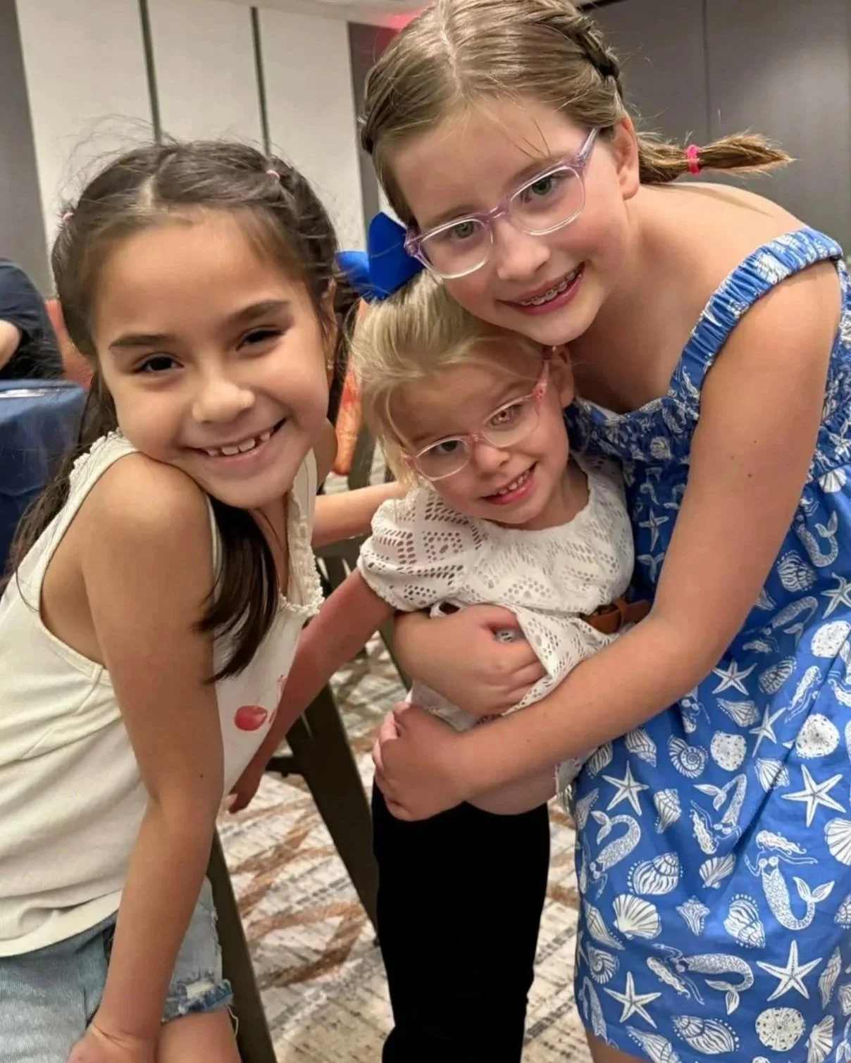 three little girls hugging