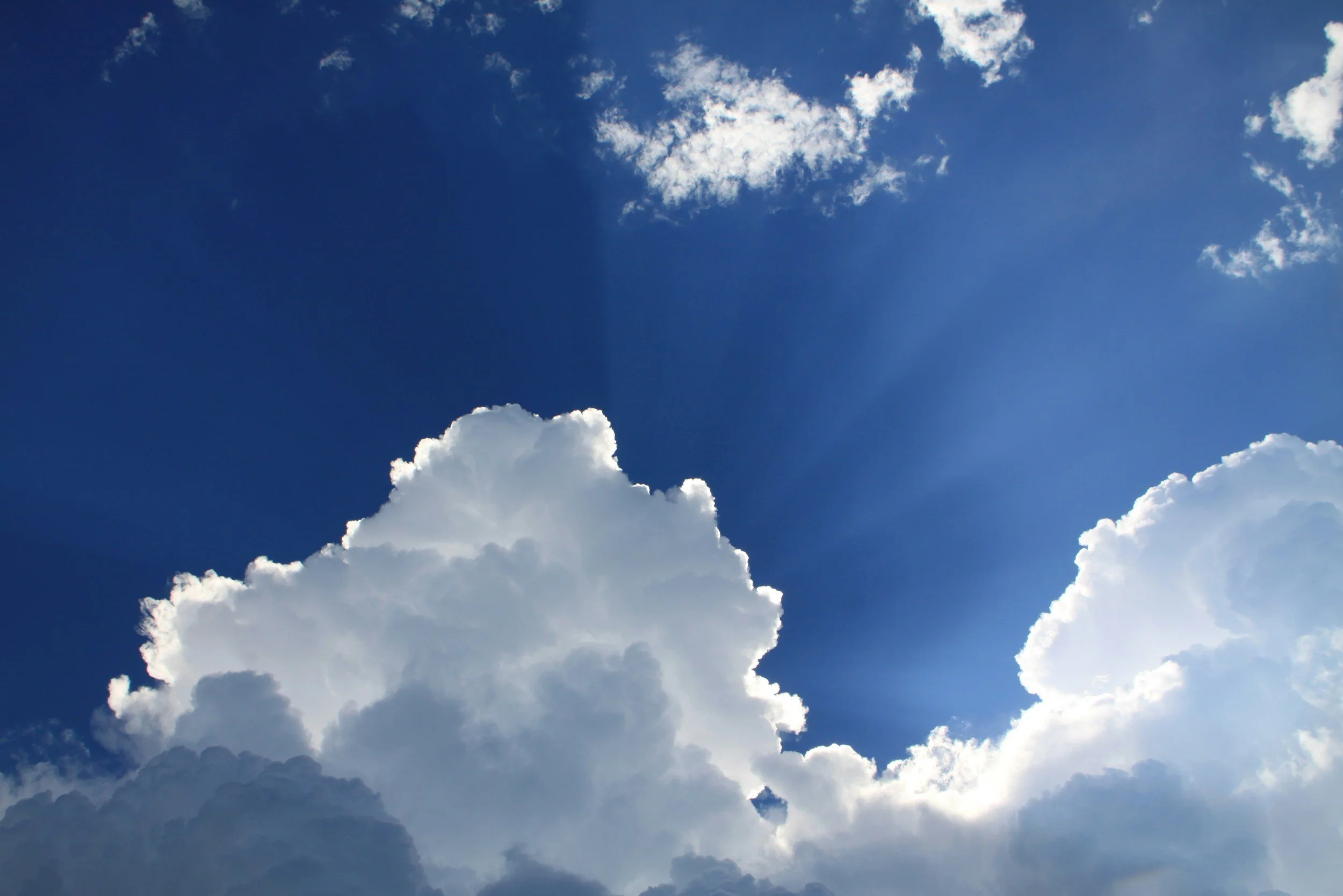 Blue sky with white fluffy clouds.