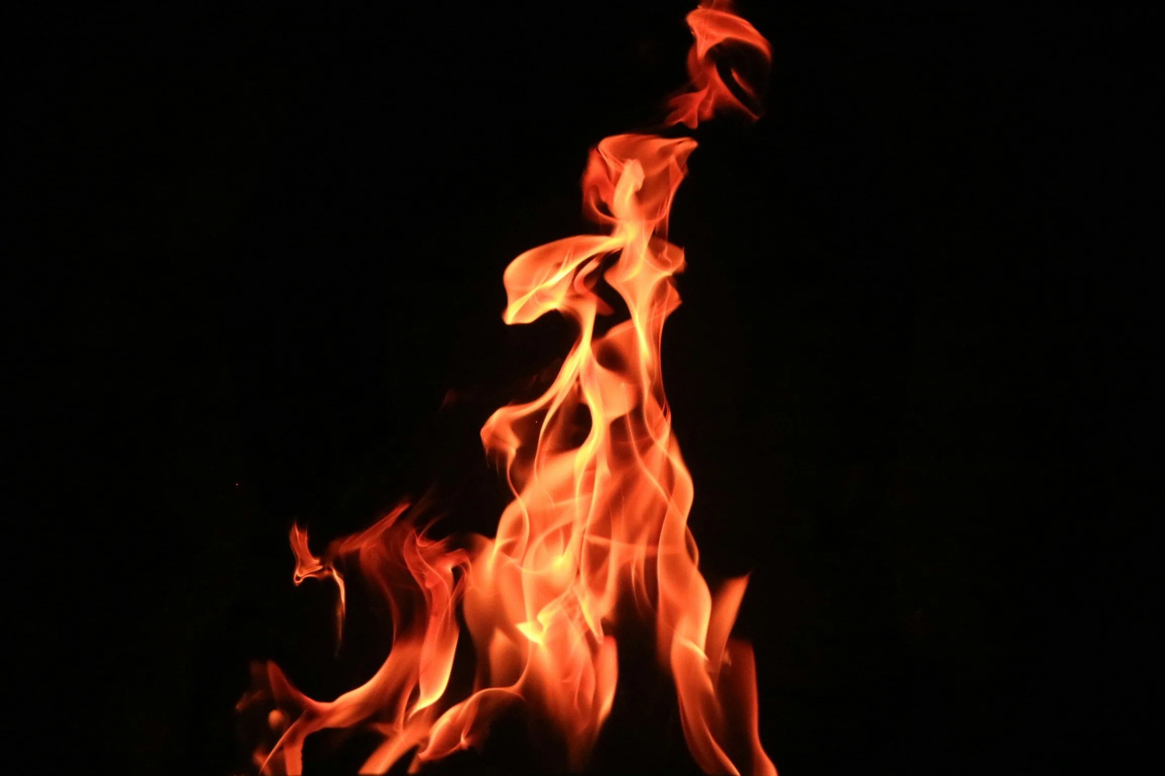 Bright orange and yellow flames rising against a black background.