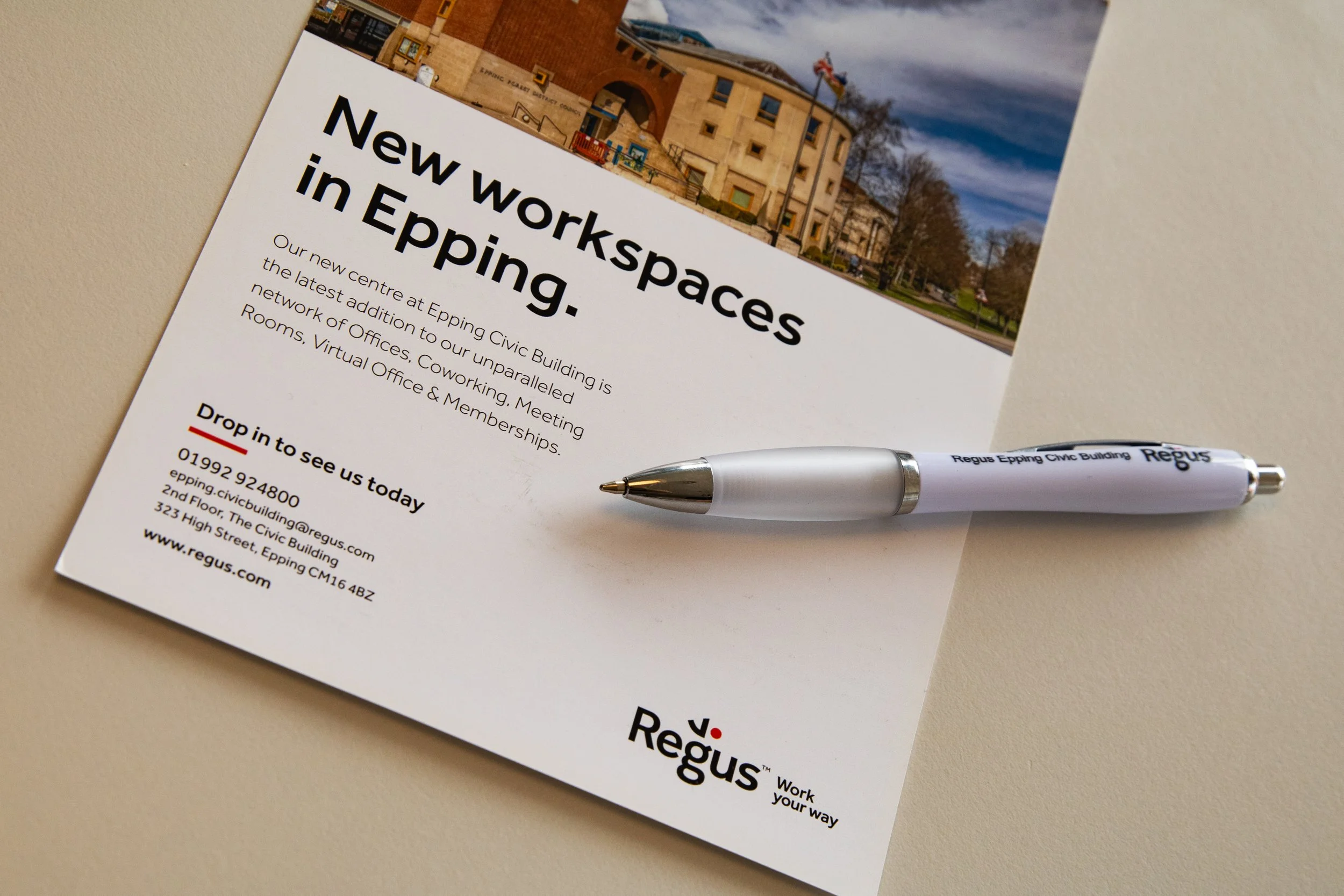A printed flyer advertising new office spaces in Epping Civic Building with a photo of the building at the top, a pen below and the Regus logo at the bottom.