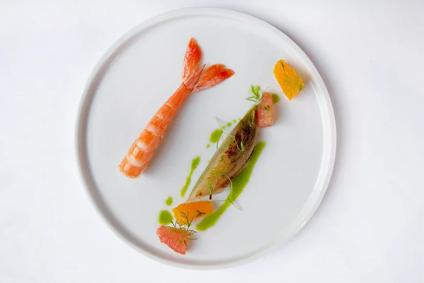 Gourmet Italian seafood dish featuring pan-seared fish and shrimp at Giando.