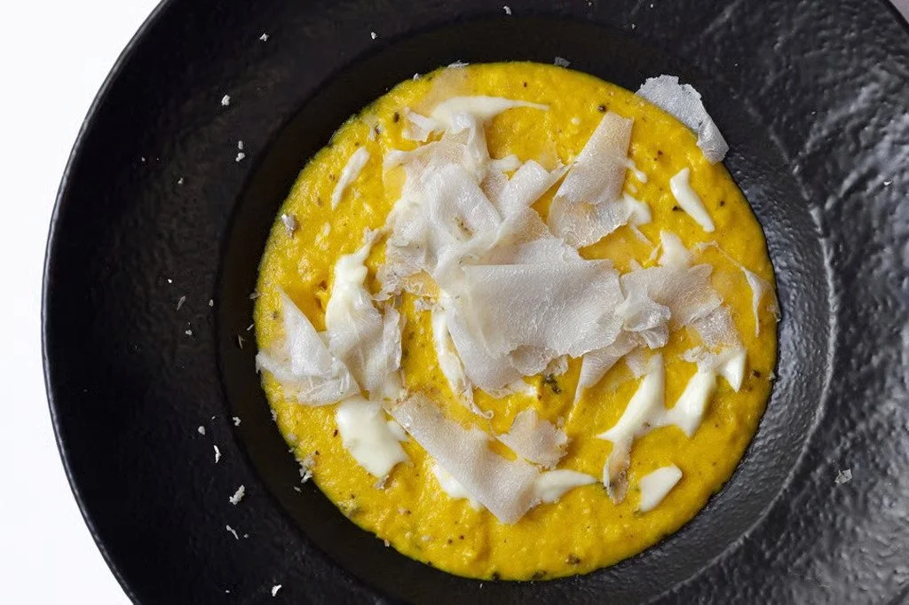 Authentic Italian egg dish topped with shaved cheese at Giando.