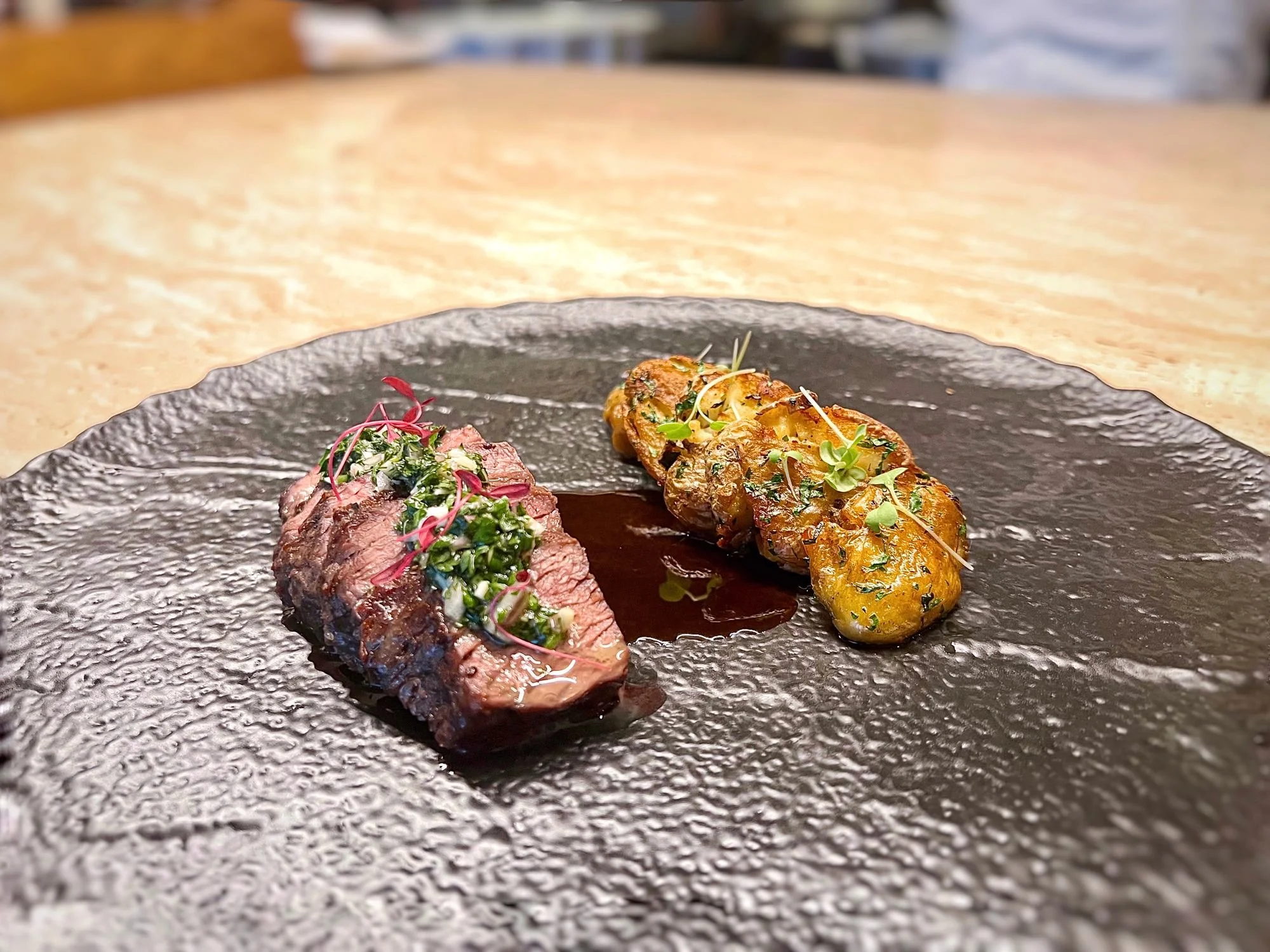 Premium Italian beef fillet with herb sauce and stuffed potatoes at Giando.