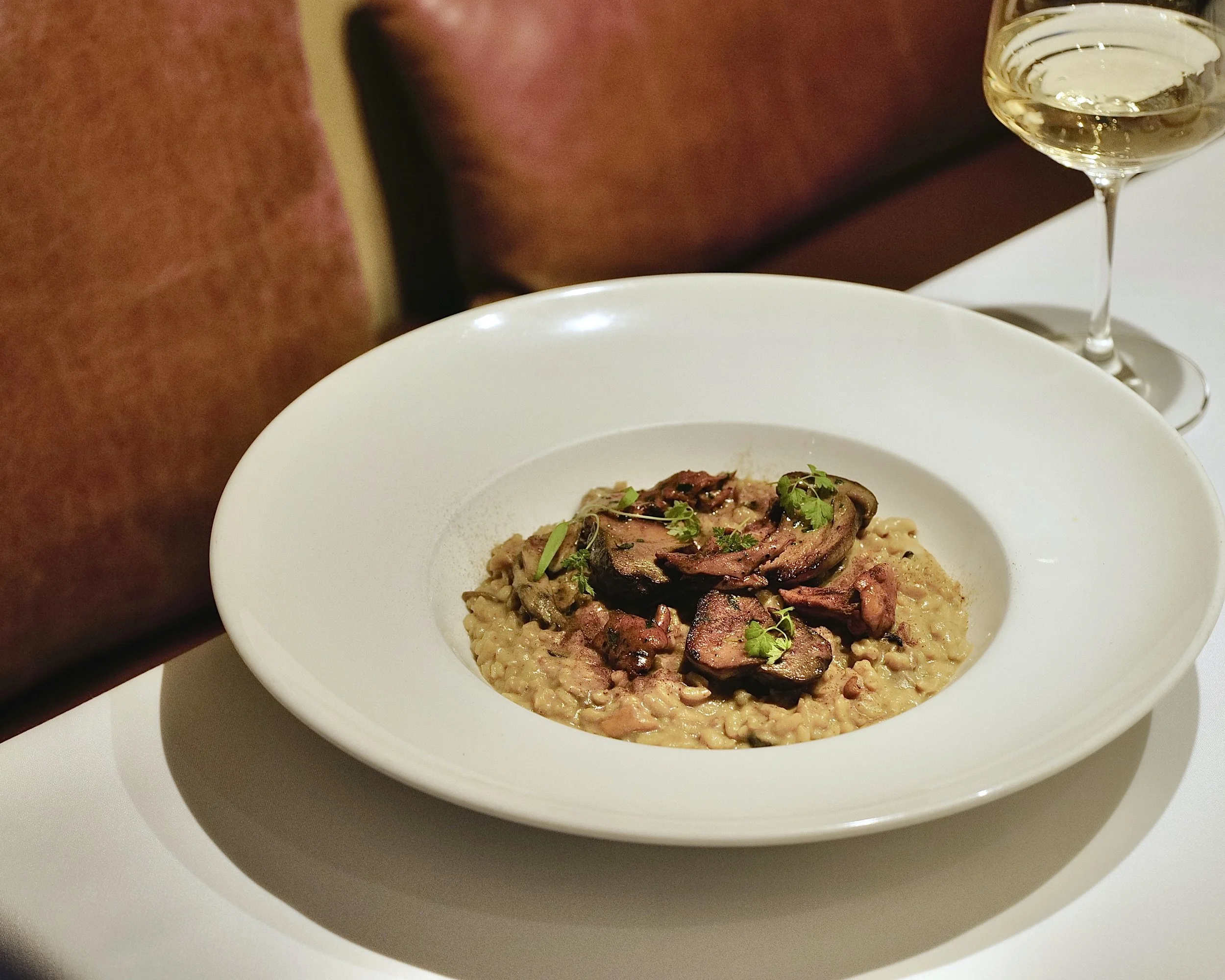 Beef risotto dish garnished with fresh herbs at Giando Italian restaurant.