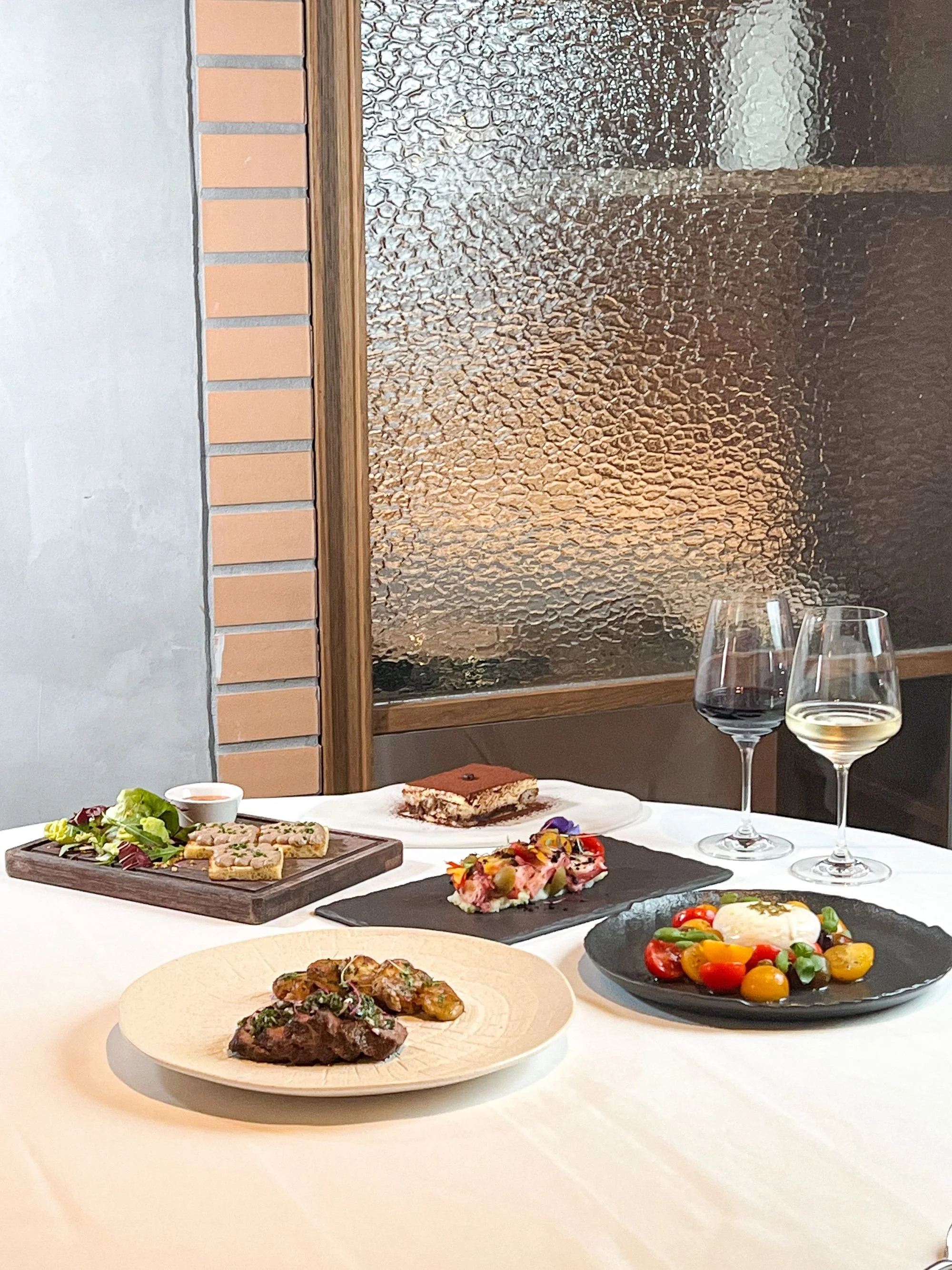 An array of authentic Italian appetizers, antipasti, and wine at Giando.