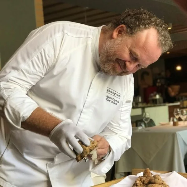 Chef preparing authentic Italian dishes in the Giando kitchen.