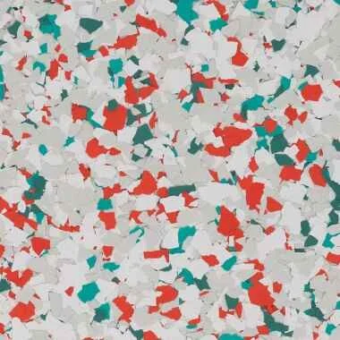 Colorful confetti in red, teal, gray, and white scattered across a surface.