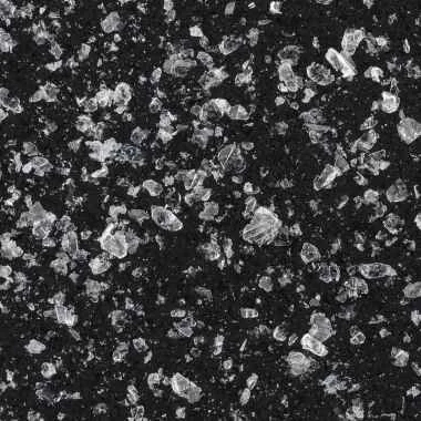 Close-up of ice pieces on a dark surface, some partially melted.