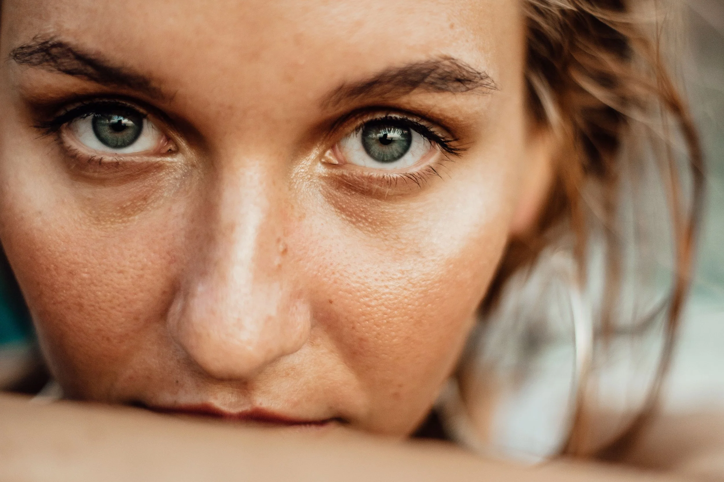 Close-up of a woman's face relaxed after IV drip and peptide service