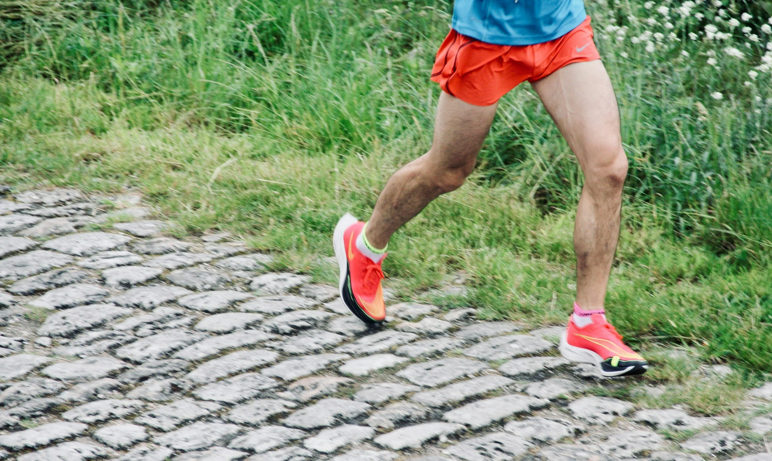 man running on a cobbled path