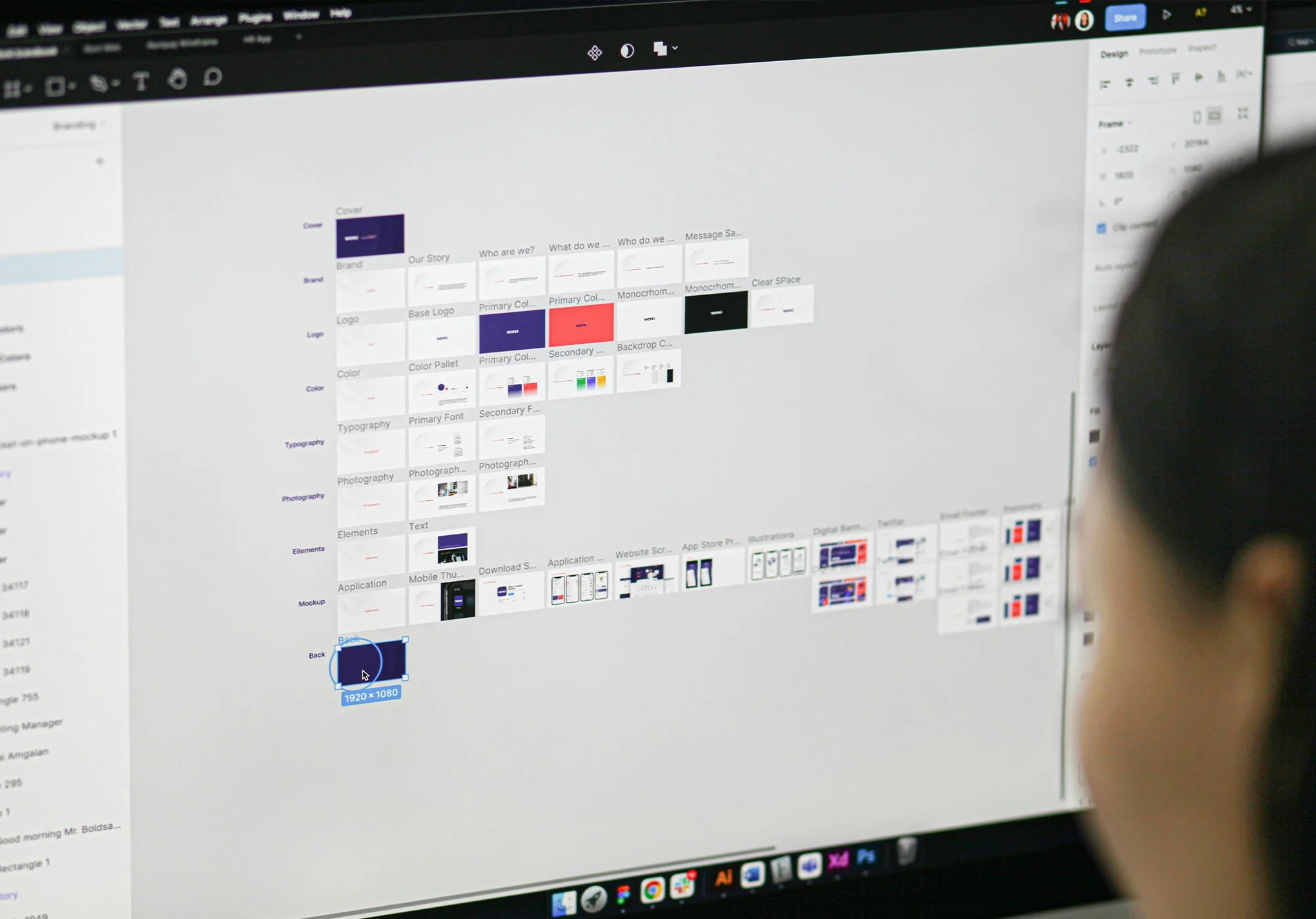 Marketing professional reviewing digital content and brand assets on a computer screen