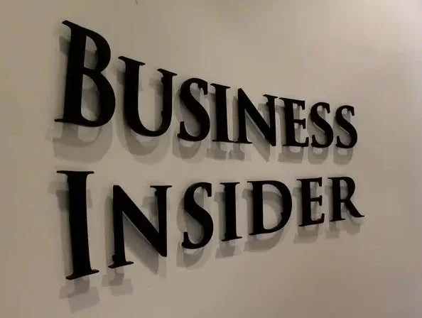 Business Insider logo on a wall representing the interview with Teresa Barerreira