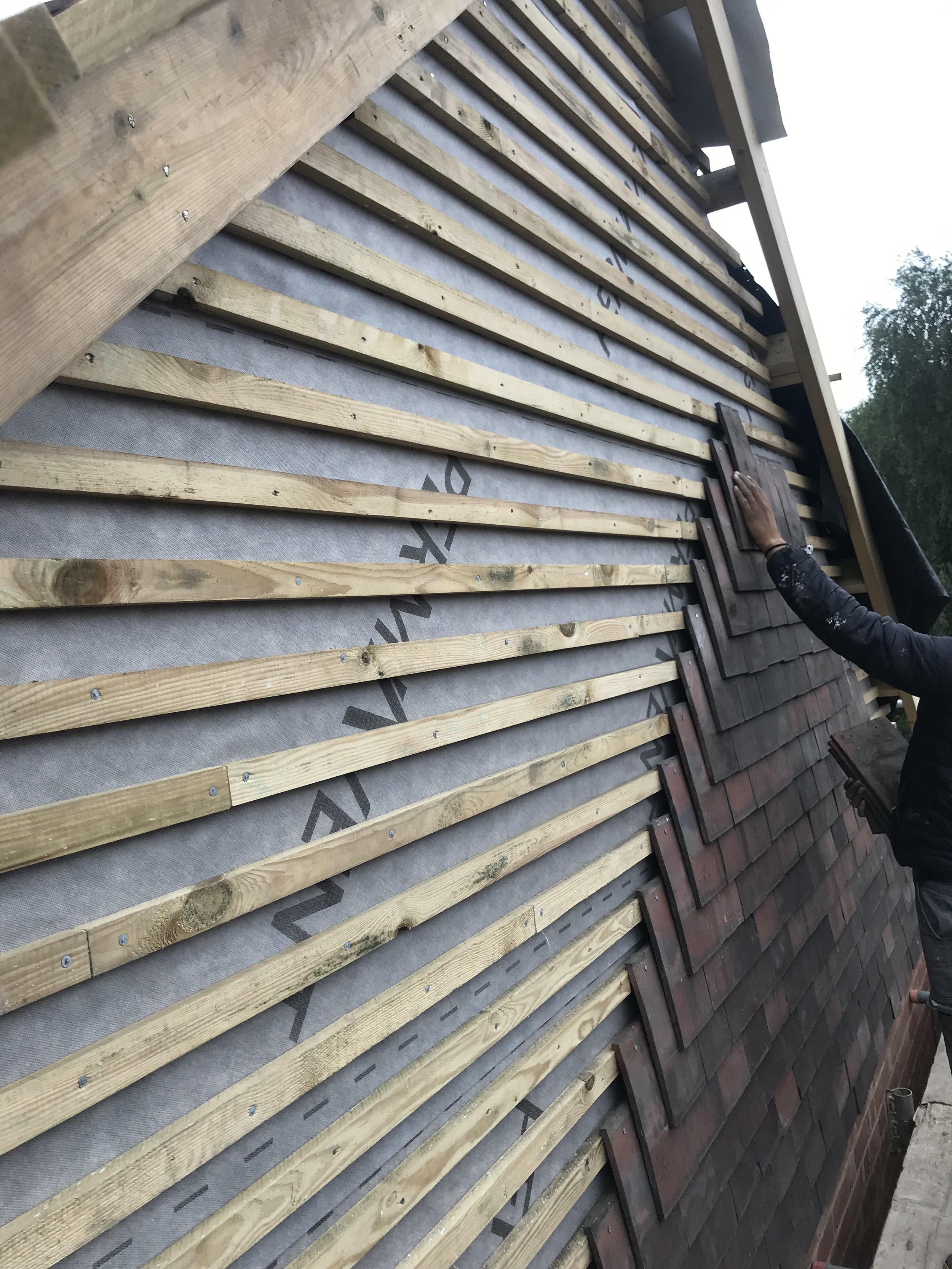 Radian Roofing specialist installing roof tiles on a residential property across Solihull and Birmingham